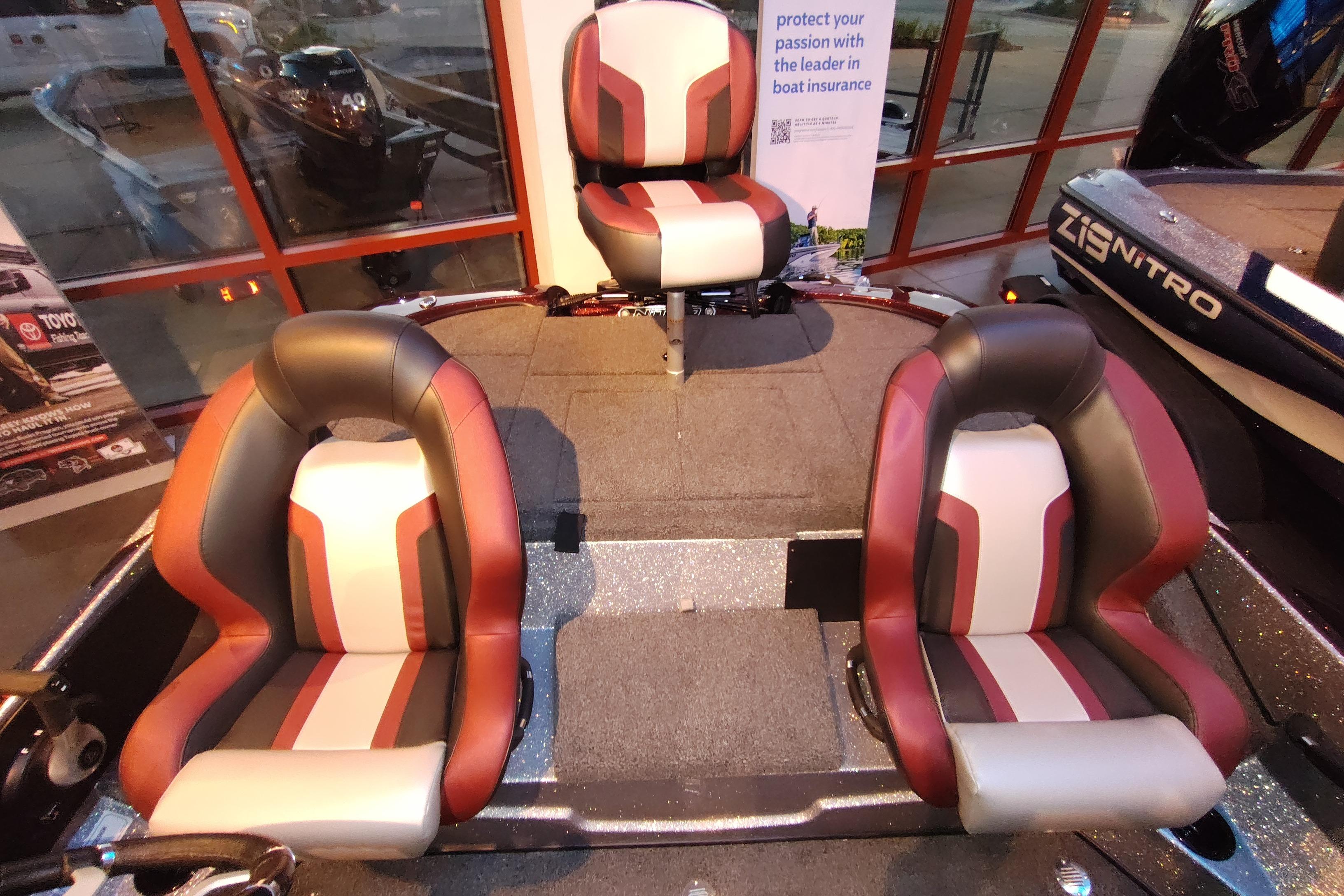 2026 Nitro Z18 boat interior with three stylish seats in a showroom setting.