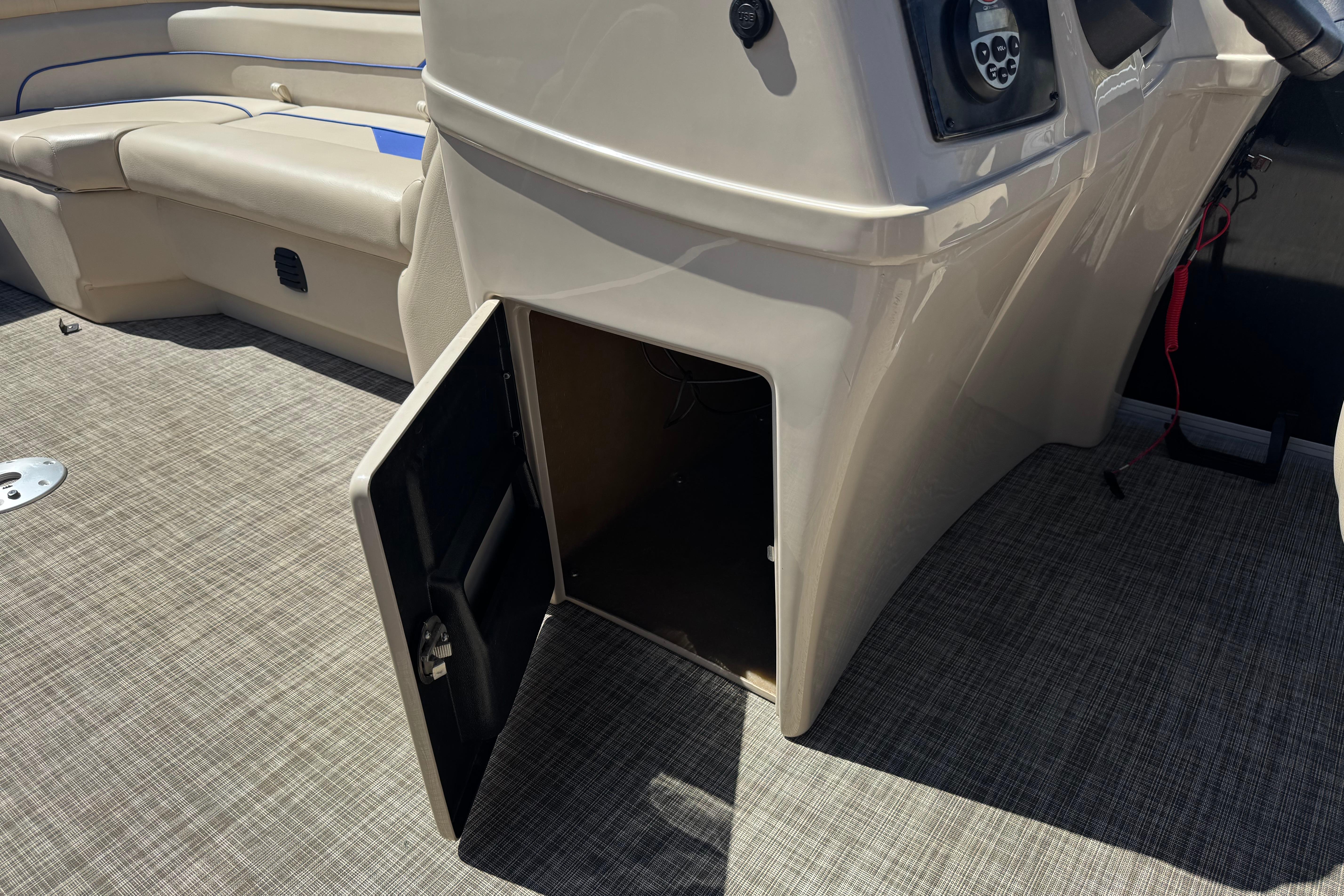 2021 SunCatcher Select 20RCX boat interior with open storage compartment and seating.