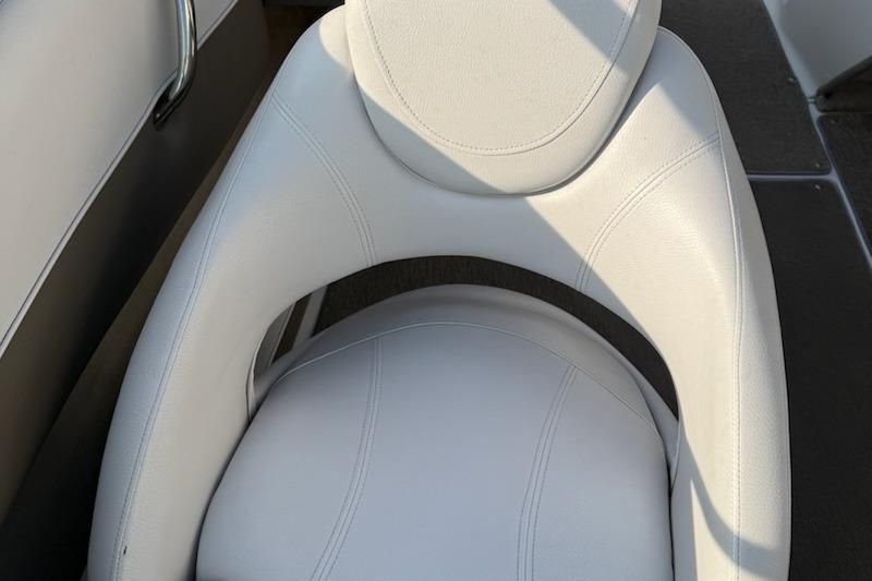 White leather seat in a 2012 195 SS boat, featuring sleek design and stitching.