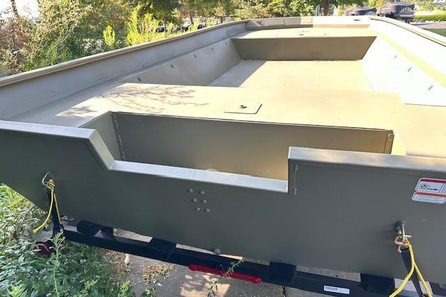 2025 Tracker GRIZZLY 2072 Utility boat, empty interior, on trailer, outdoors.