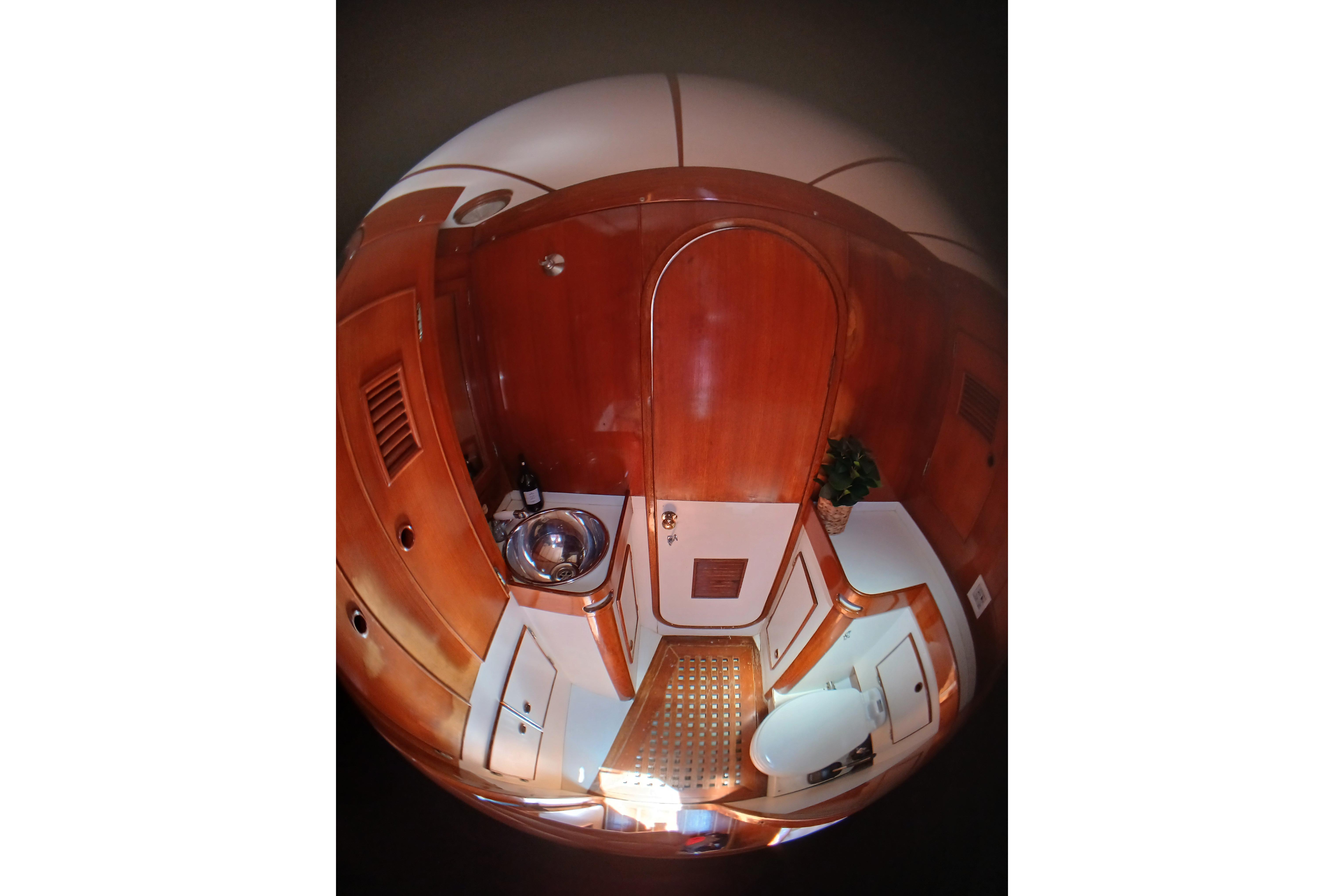 Interior of 1981 SKYE 51 yacht bathroom with wooden finish and modern fixtures.