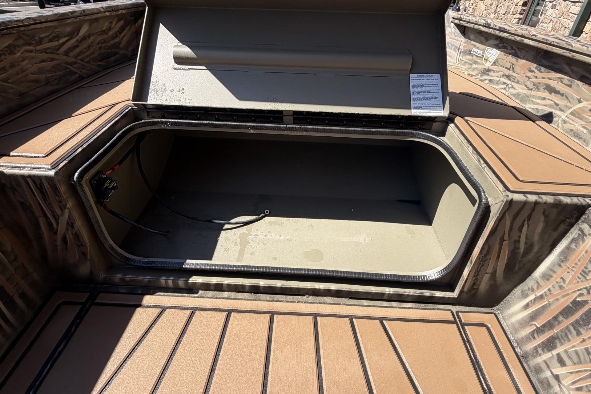 Open storage compartment in 2026 Tracker Grizzly 1650 T Prairie Wings Edition boat.
