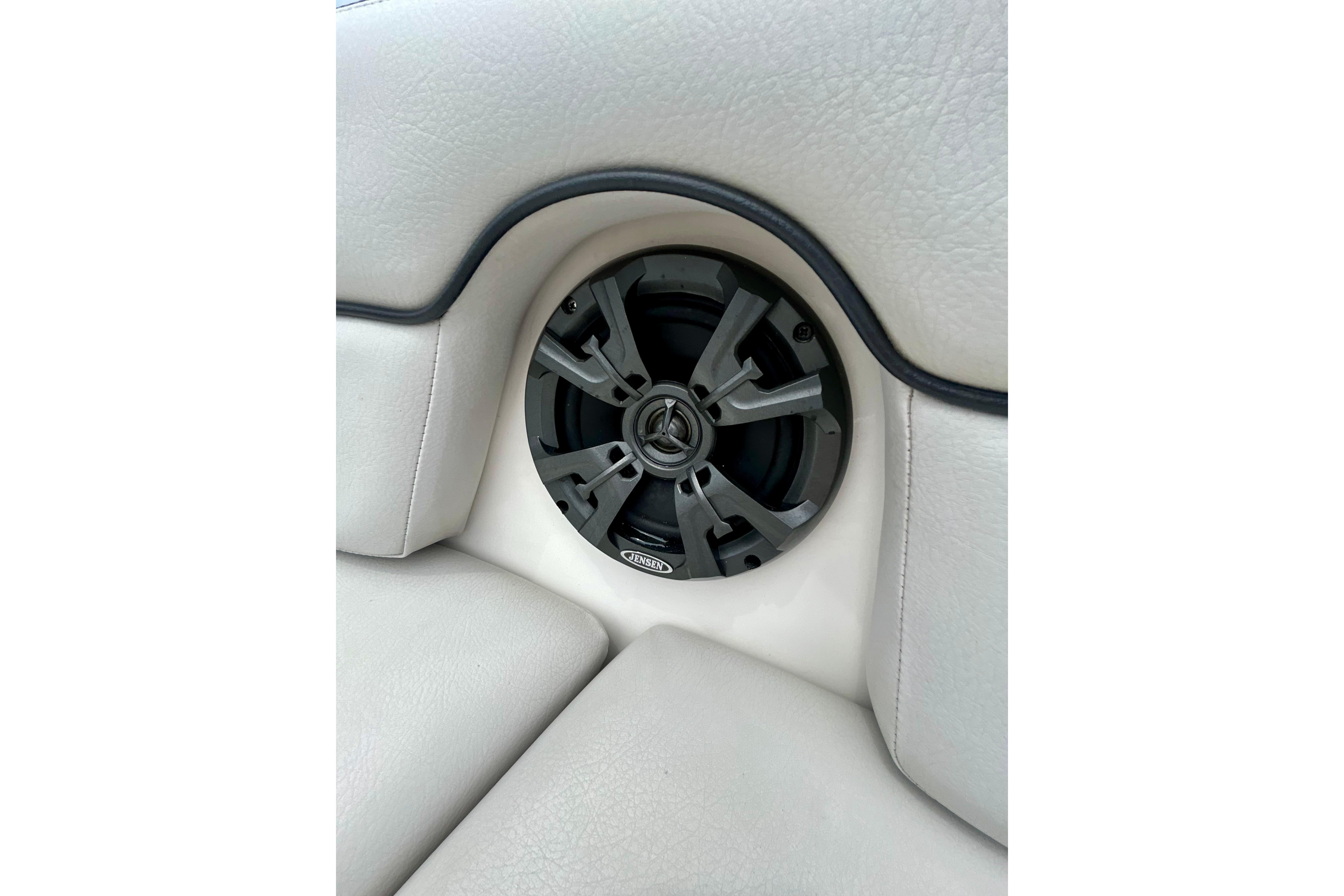 Speaker system on 2015 Yamaha Boats AR210, integrated into white cushioned seating.