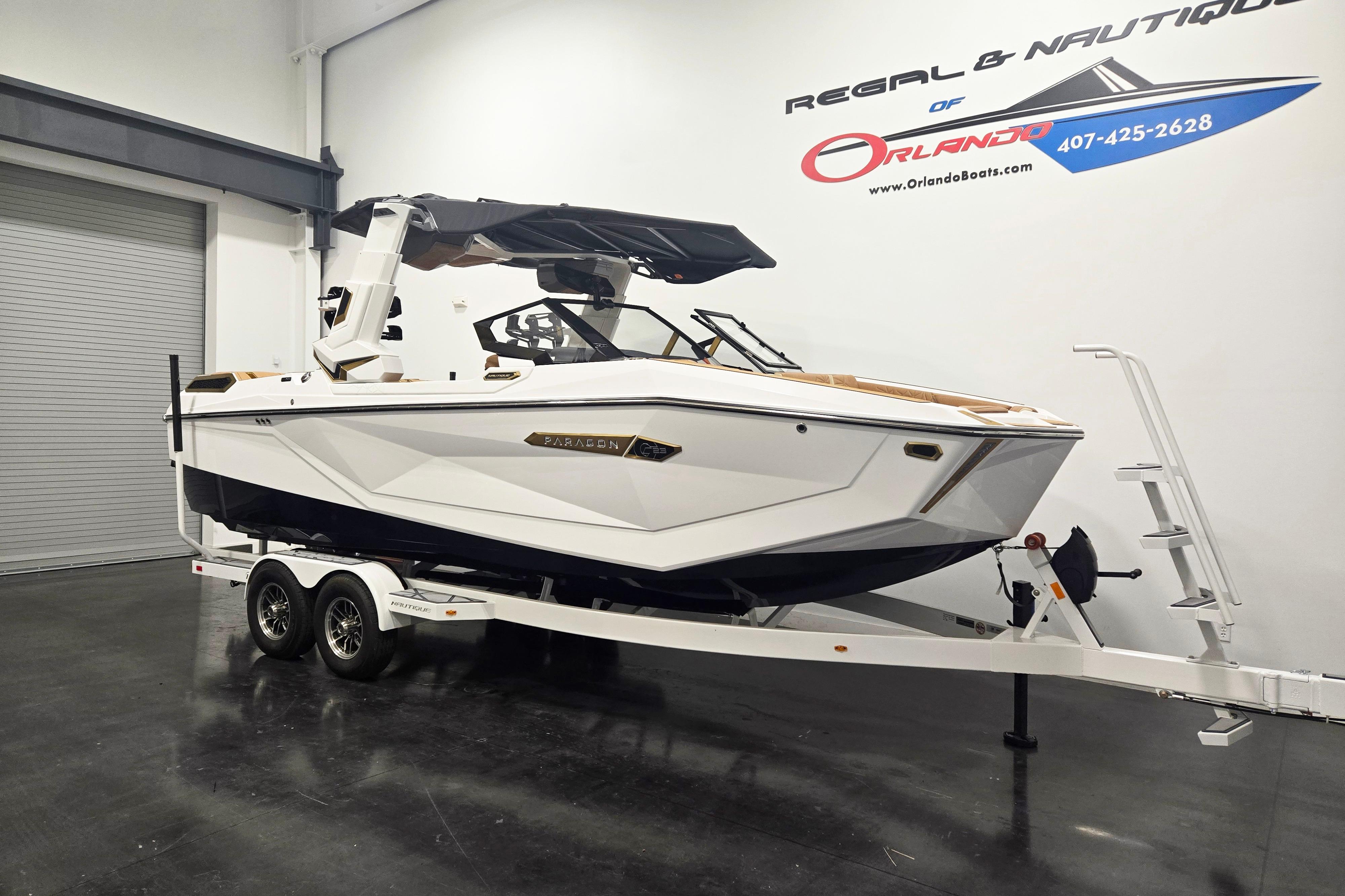 2026 Nautique Super Air Nautique G23 Paragon boat on trailer in showroom.