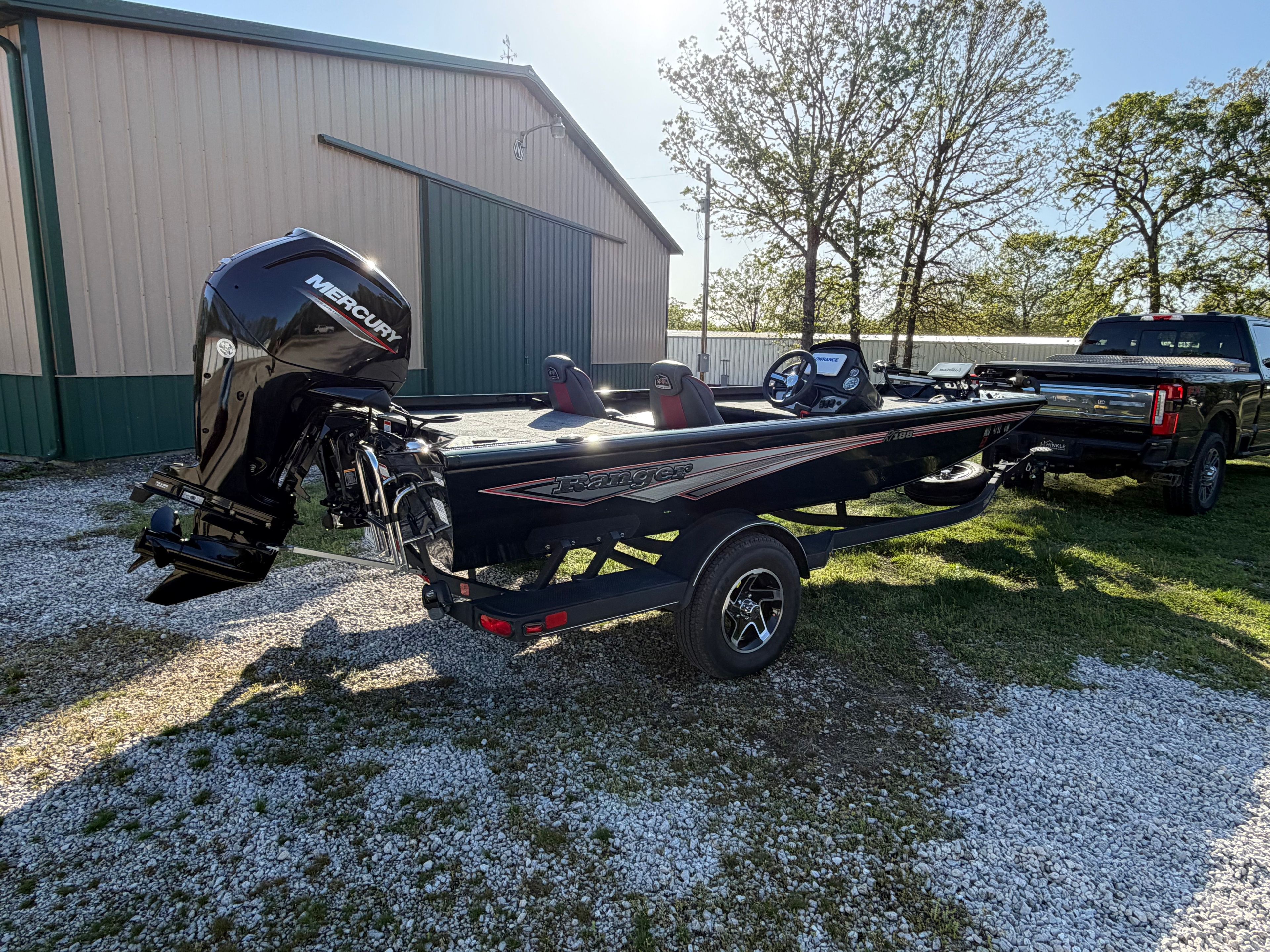 2024 Ranger RT188 boat with Mercury engine, parked beside a building.