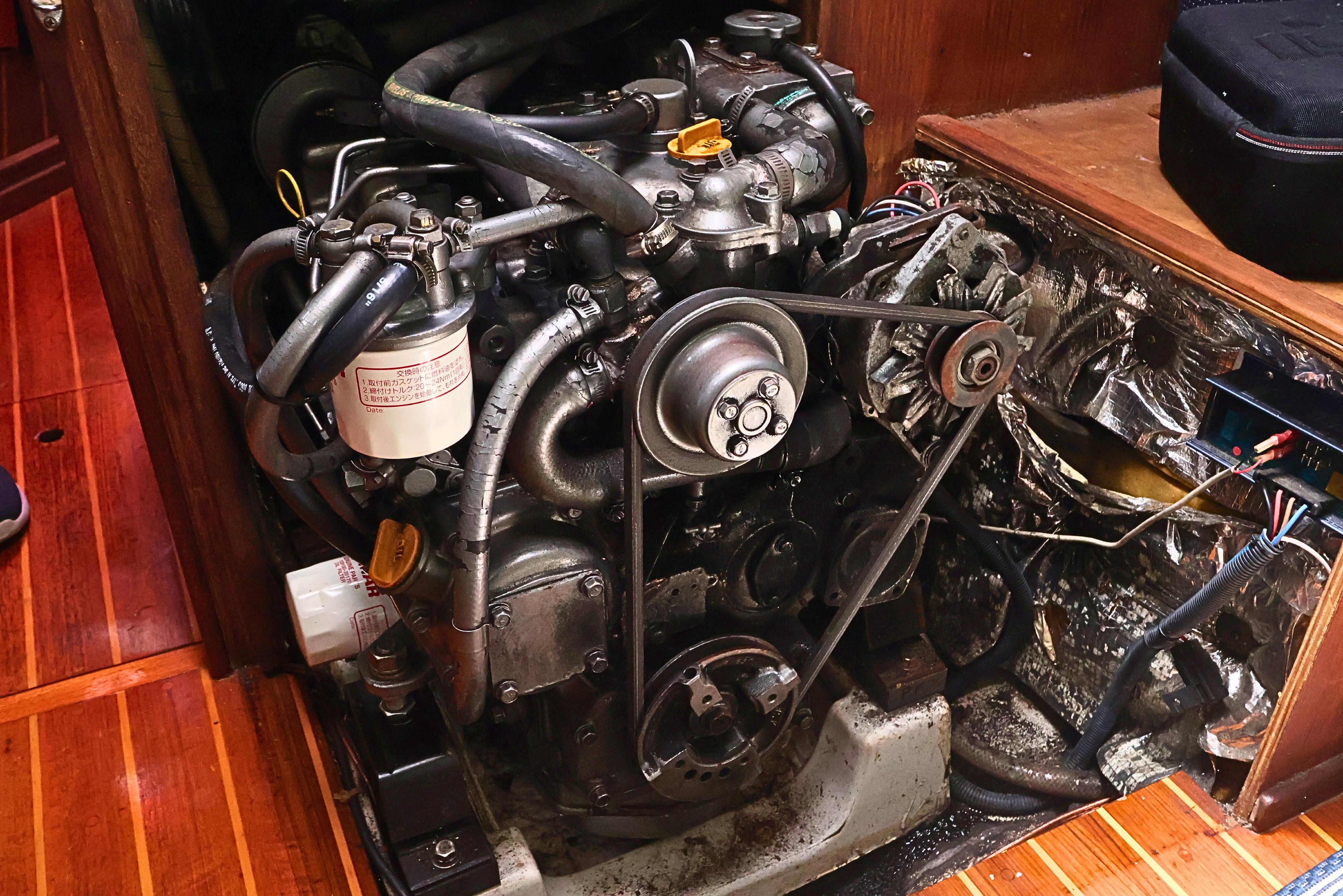 Engine compartment of a 1989 J Boat J 40, showcasing mechanical components and wiring.