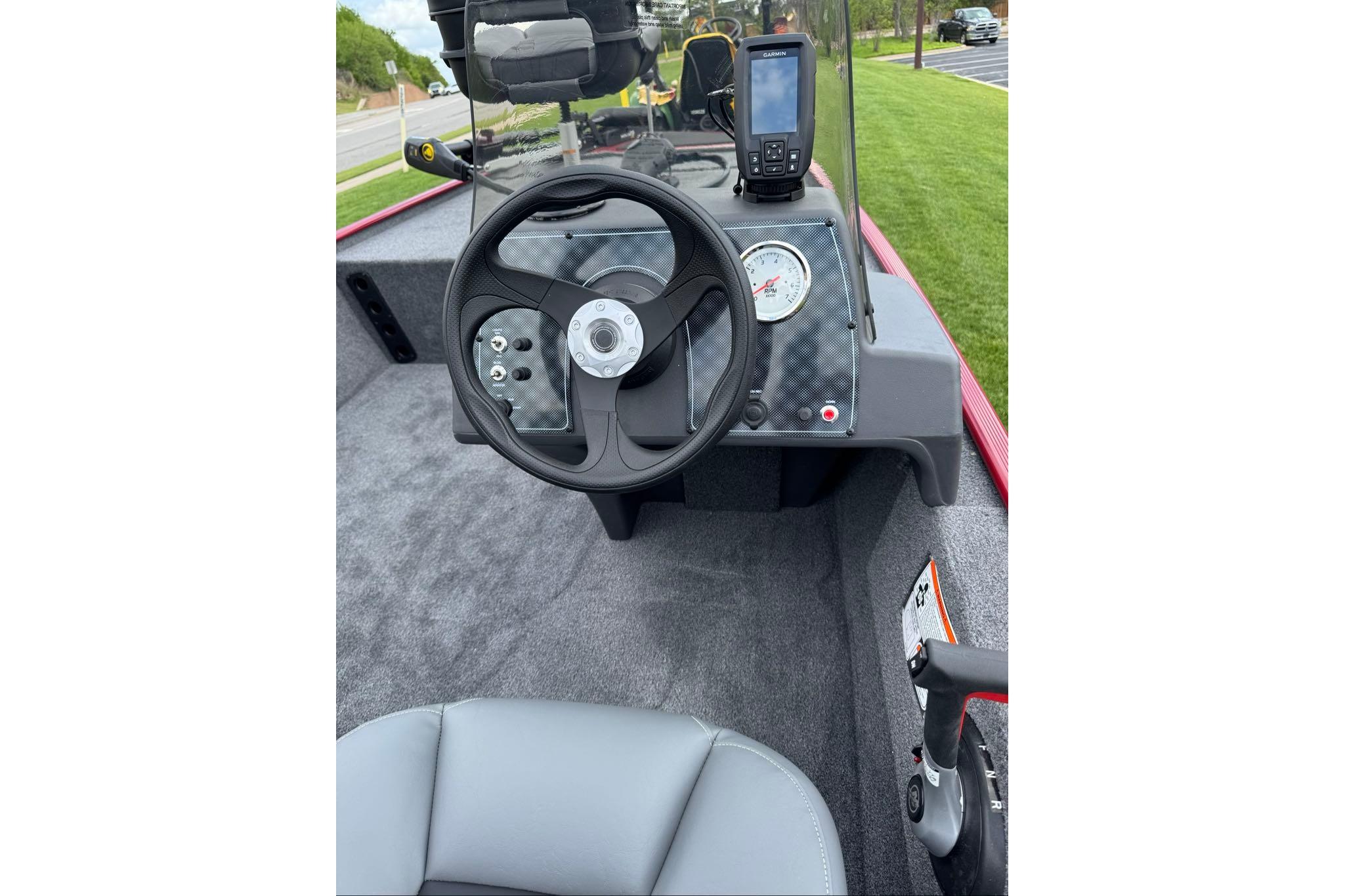 2026 Tracker Bass Tracker Classic XL boat dashboard with steering wheel and navigation system.