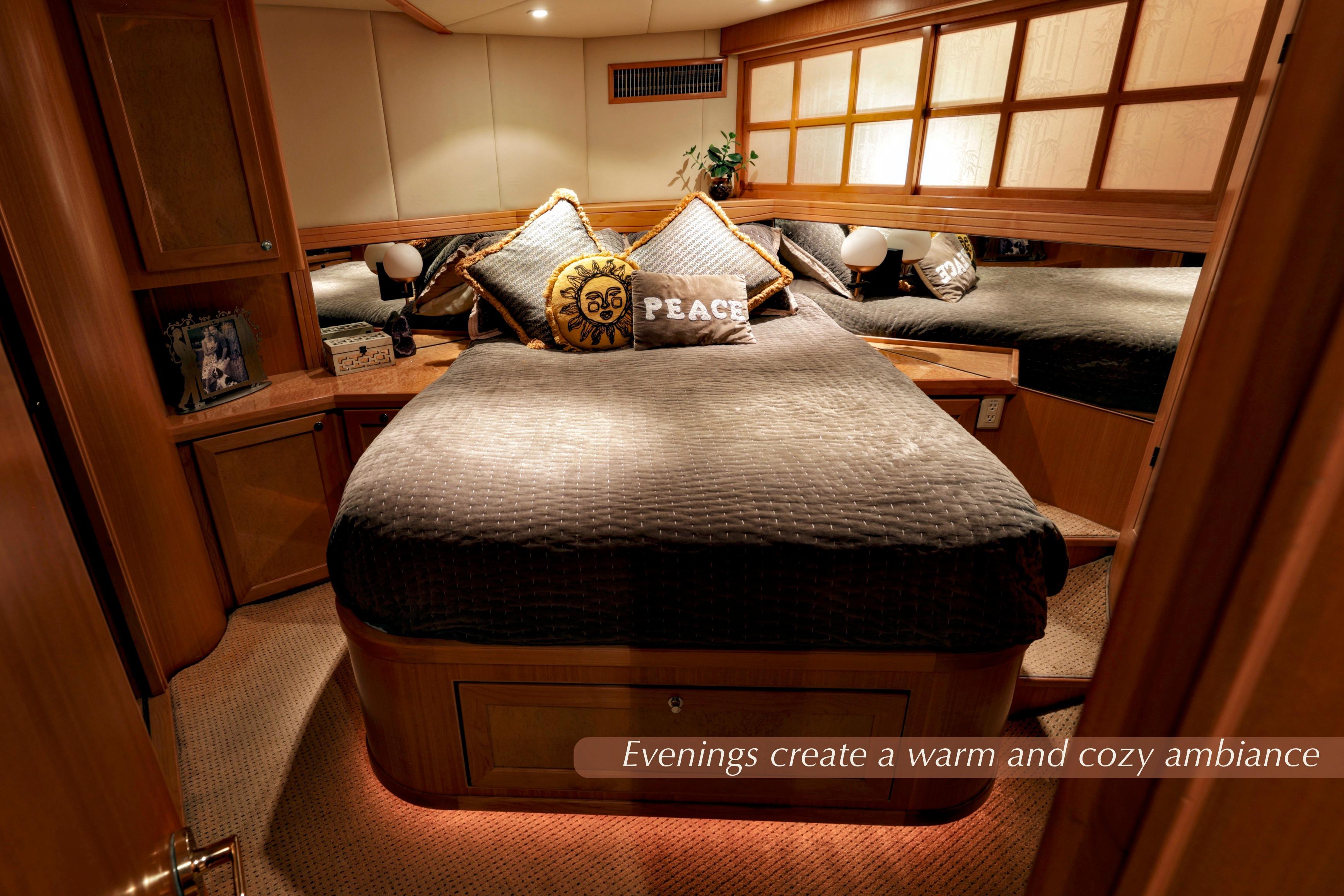 Luxurious 2004 McKinna 57 Pilothouse bedroom with warm lighting and cozy decor.