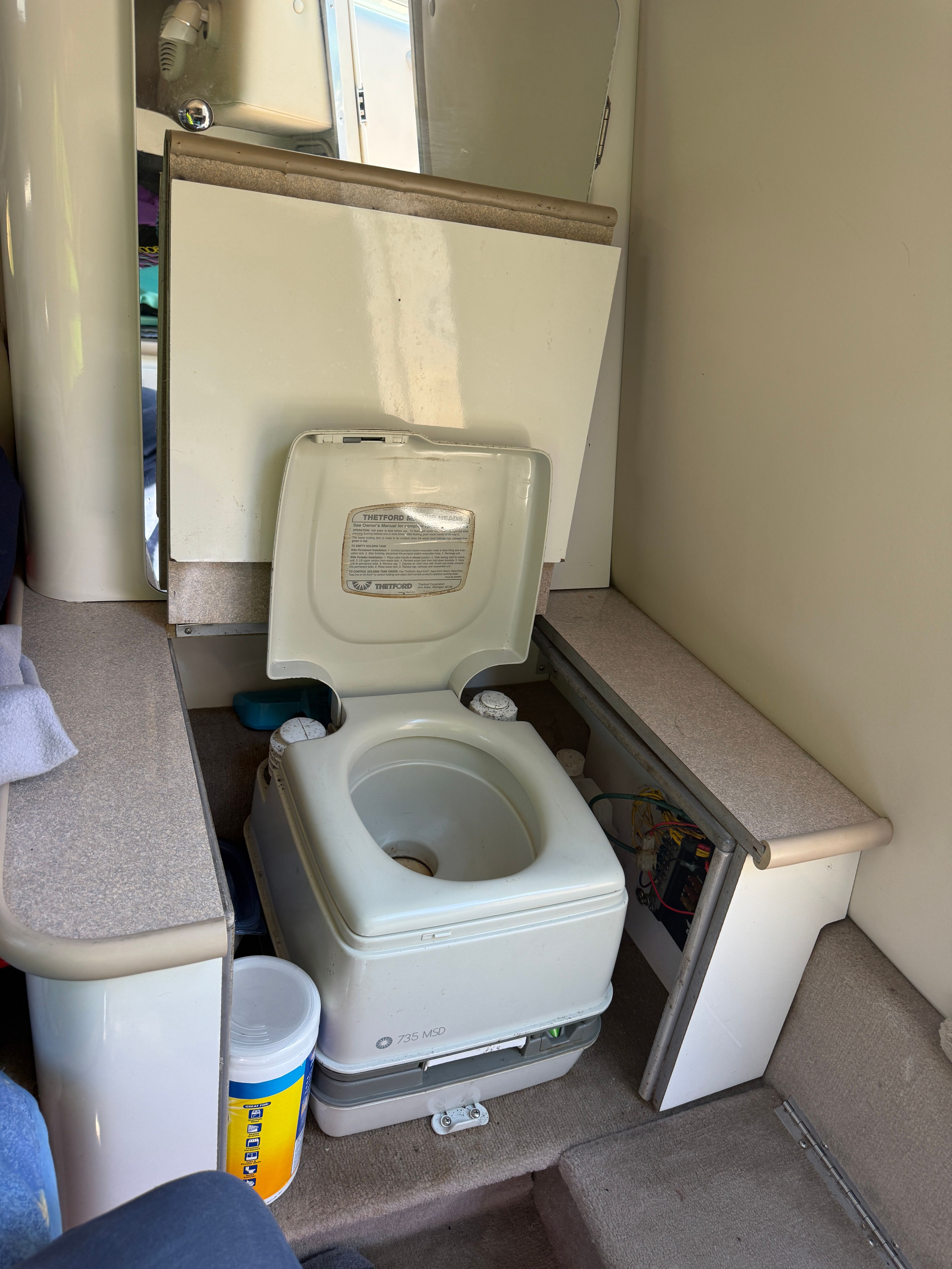 Interior of 1999 Custom 2335 Cuddy cabin with portable toilet.