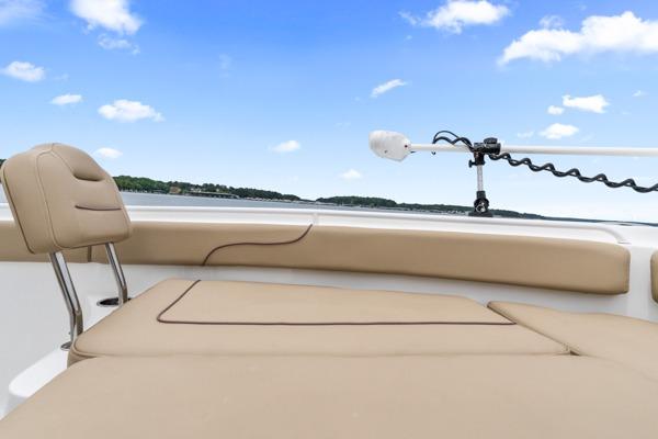 2018 Sea Hunt Gamefish 27 boat interior with tan seating and clear blue sky.