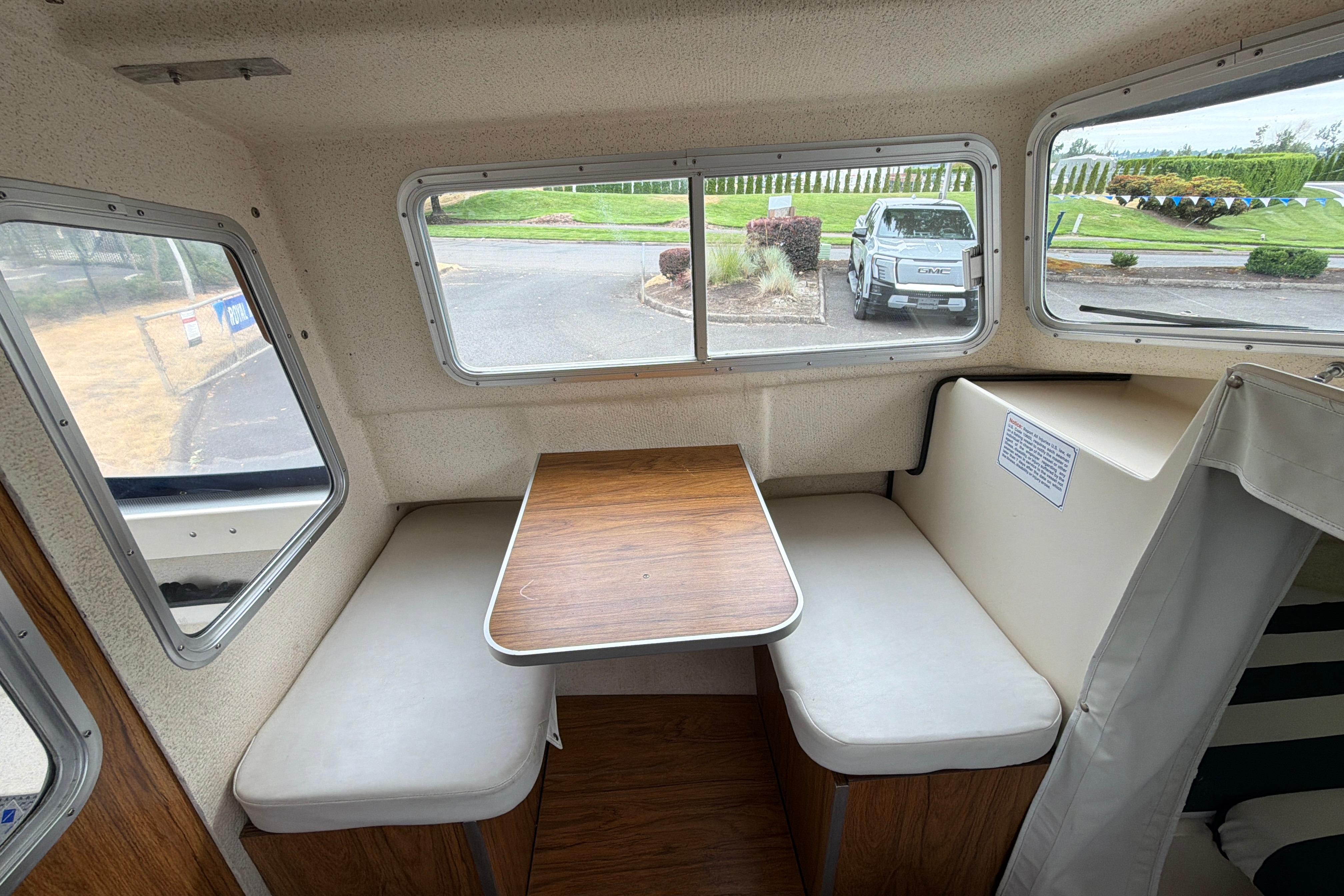 Interior of a 1989 C-Dory 22' Angler boat with seating and table.