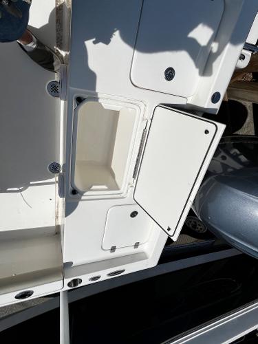 2024 Key West 188 Bay Reef boat with open storage compartment.