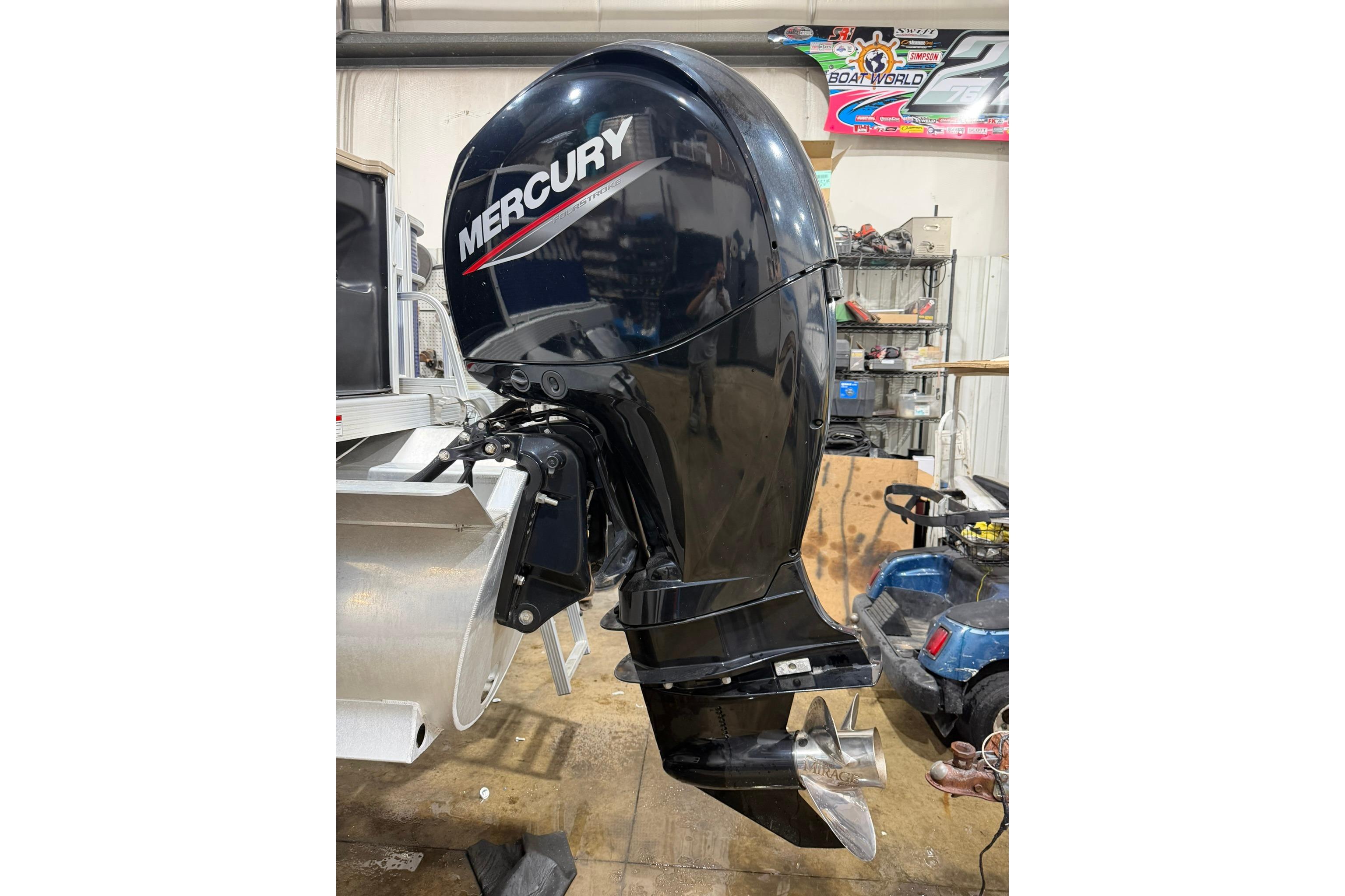 Mercury outboard motor on a 2020 Bennington SX 22 SFX boat in a workshop.