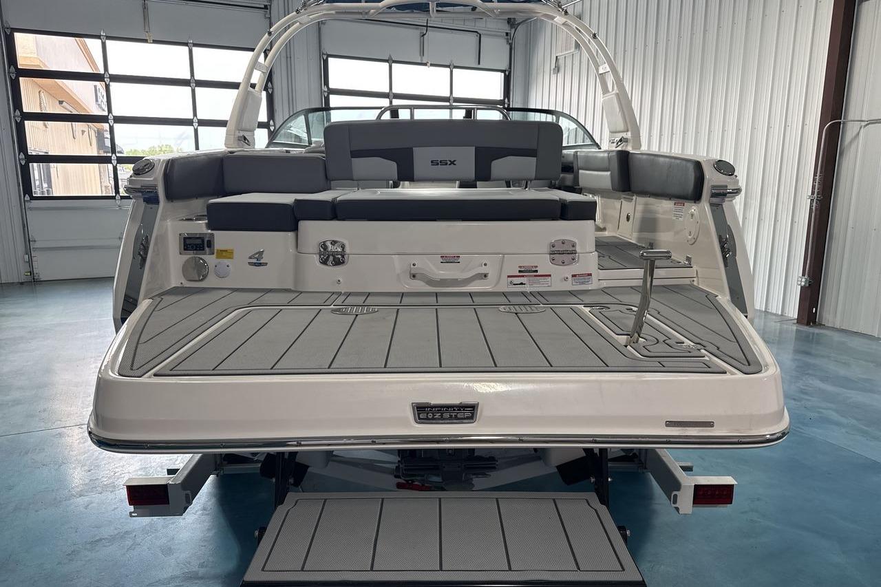 The image shows the stern of a Chaparral SSX 4 boat in a warehouse.