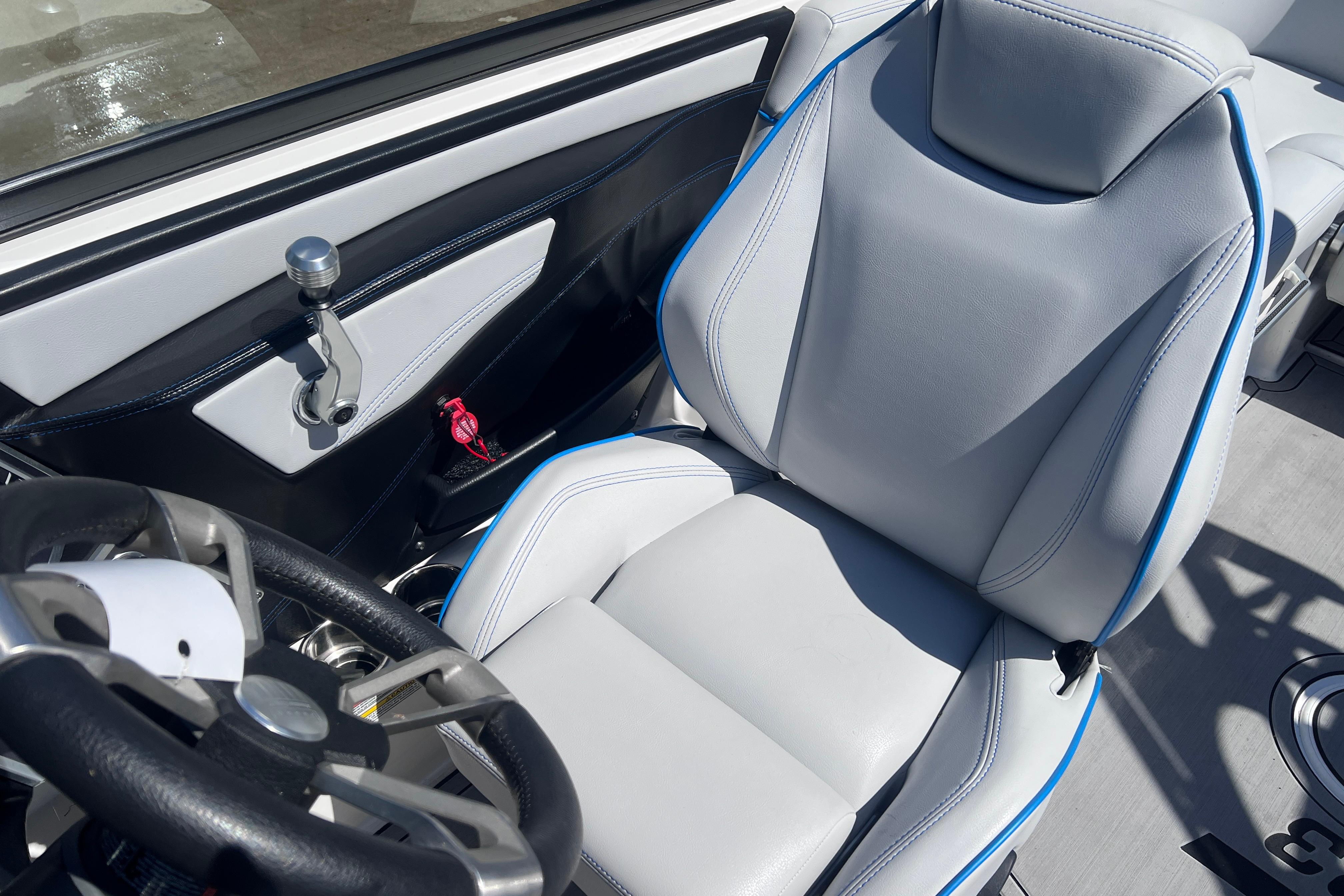 2021 MasterCraft XT23 boat interior with sleek steering wheel and comfortable seating.