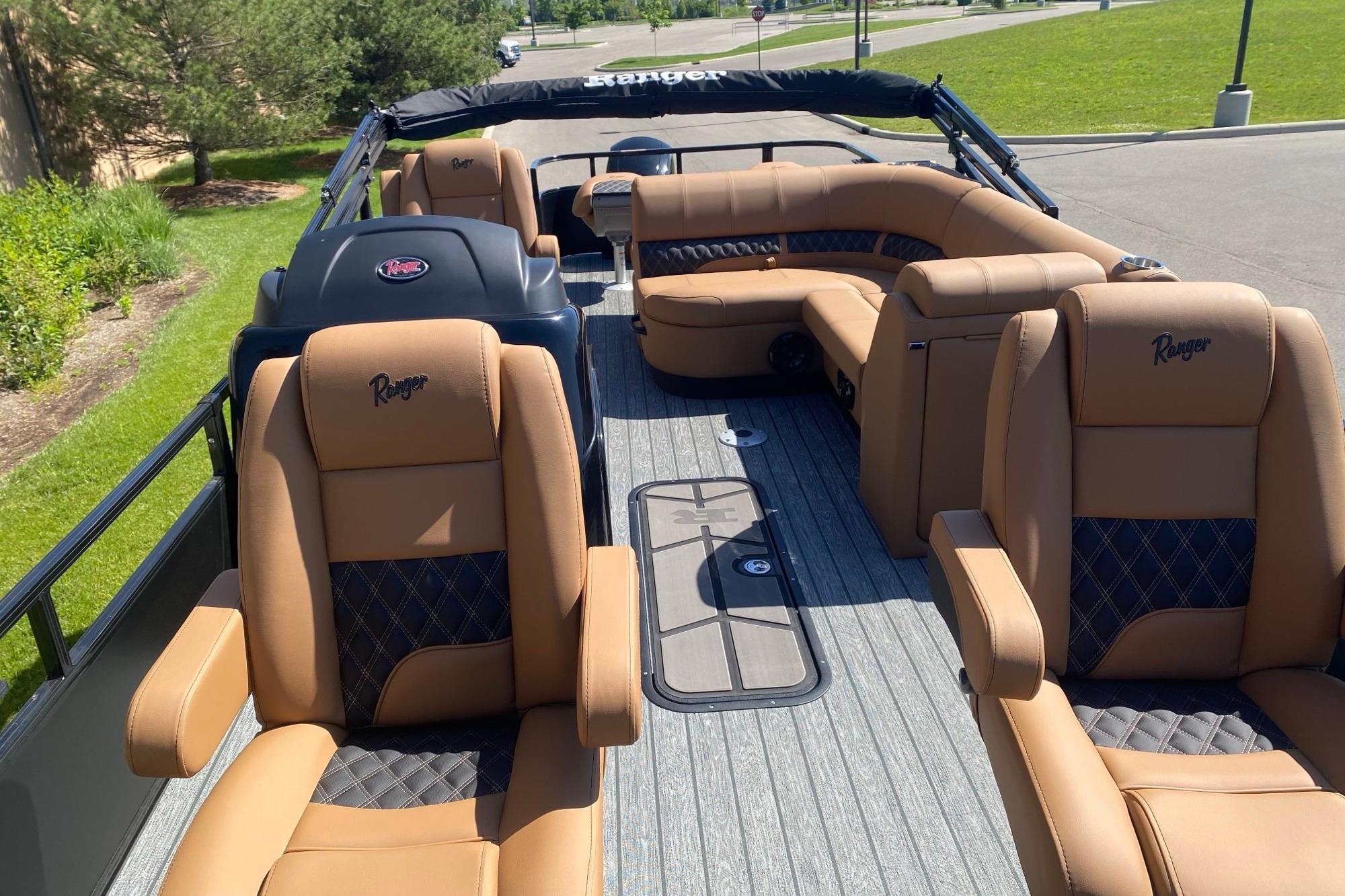 Luxurious interior of 2026 Ranger 223F boat with tan leather seating and modern design.