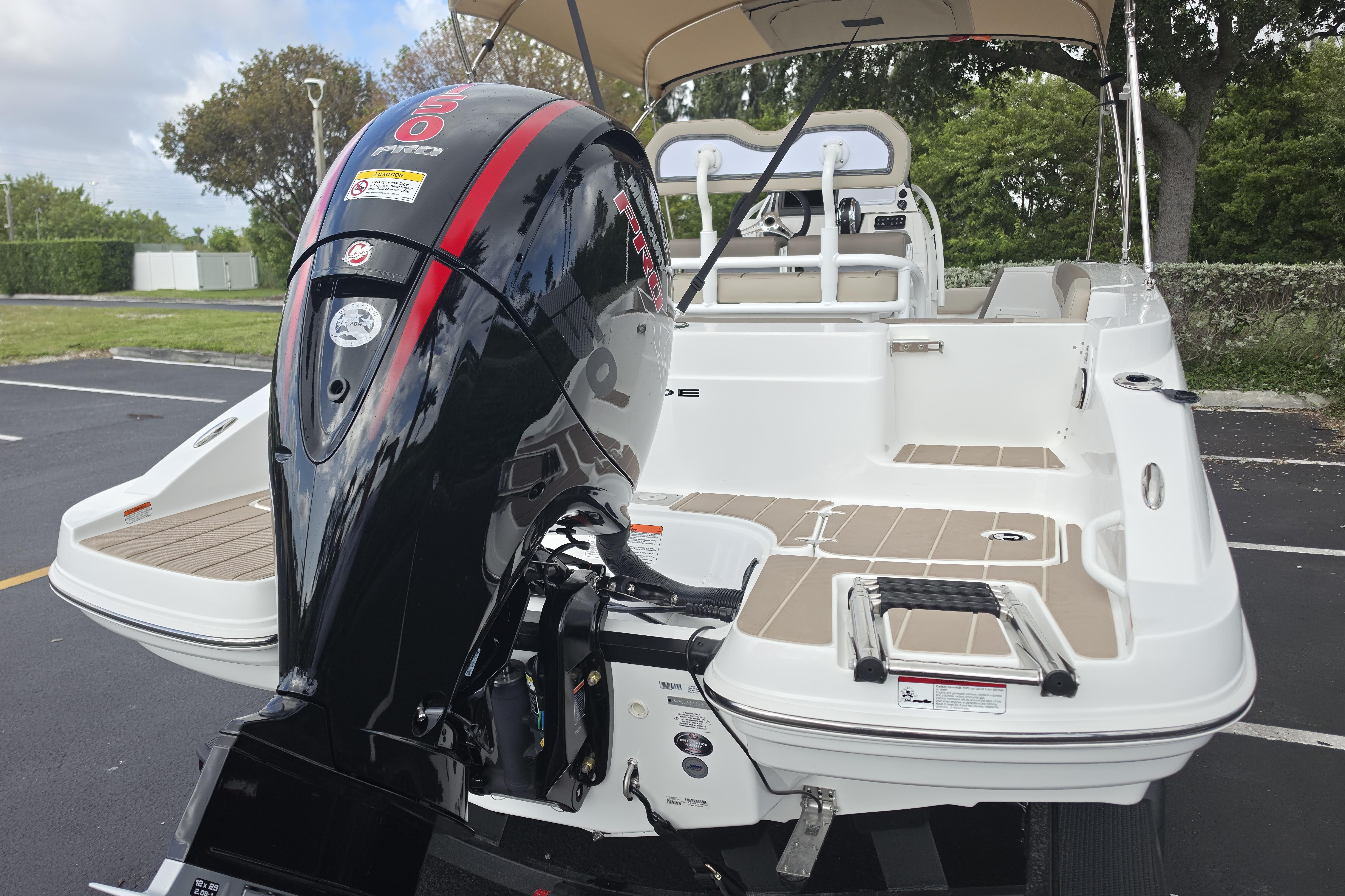 2026 Tahoe 2150 CC boat with powerful outboard motor in a parking lot.