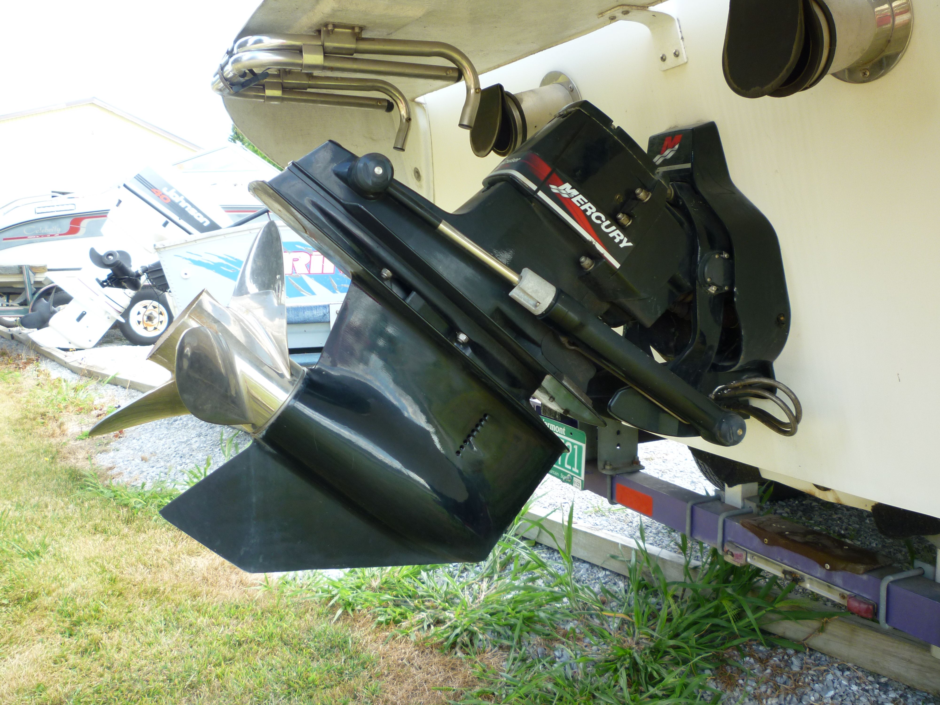 Velocity 280 boat with Mercury outboard motor, 2000 model, on a trailer.