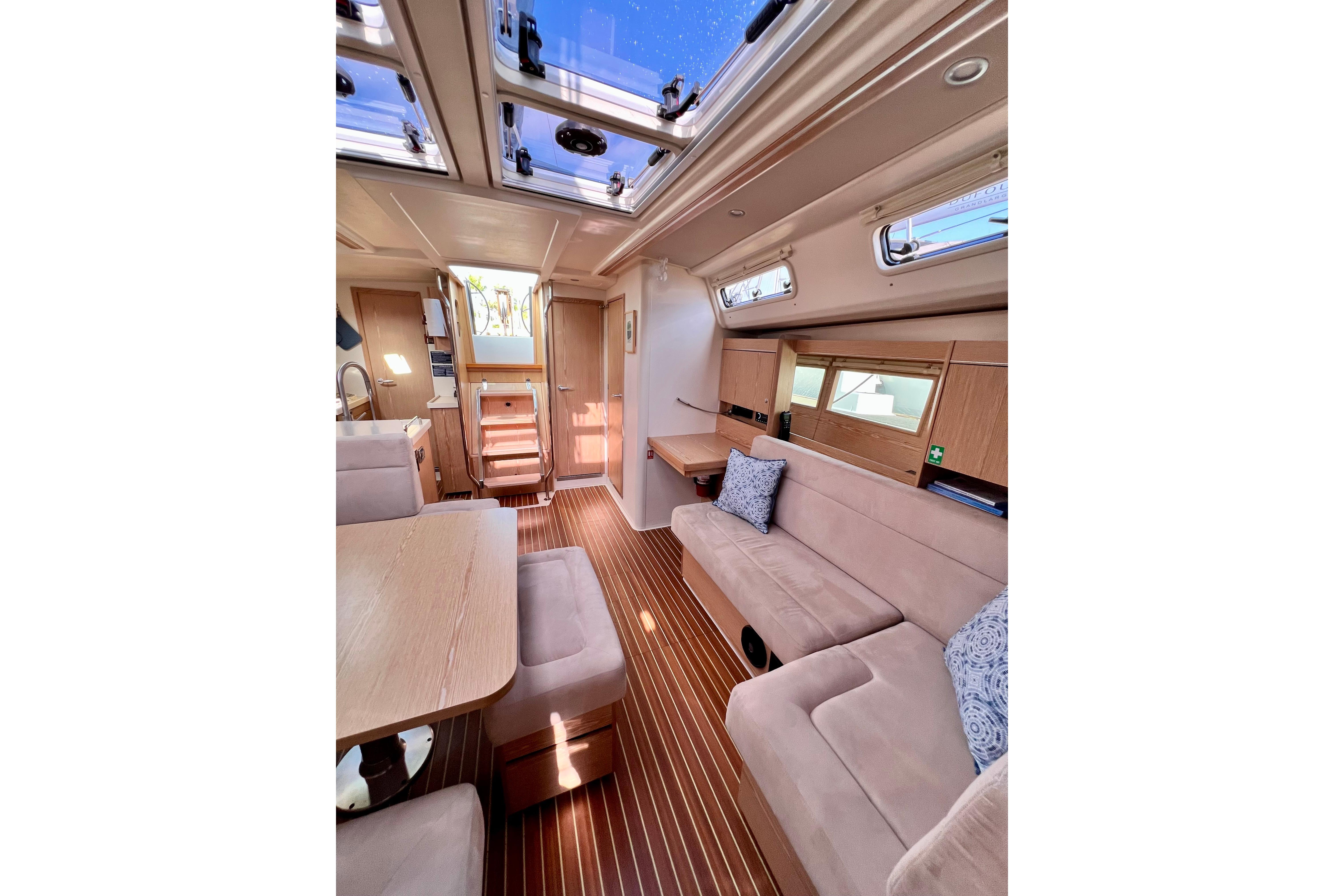Interior of 2016 Hanse 455 yacht with modern furnishings and skylights.