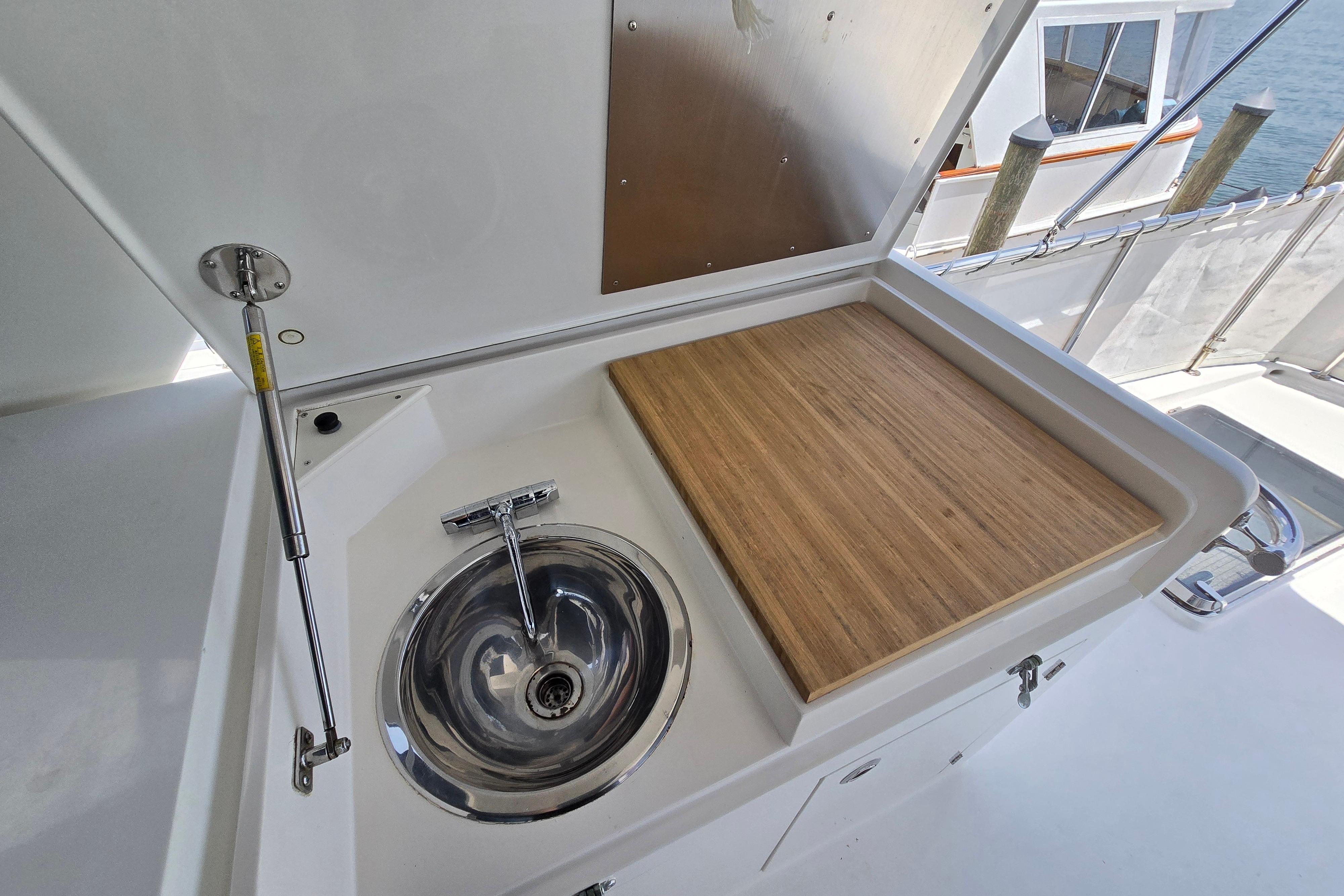 Outdoor sink and cutting board on 2004 Grand Harbour 58 yacht deck.