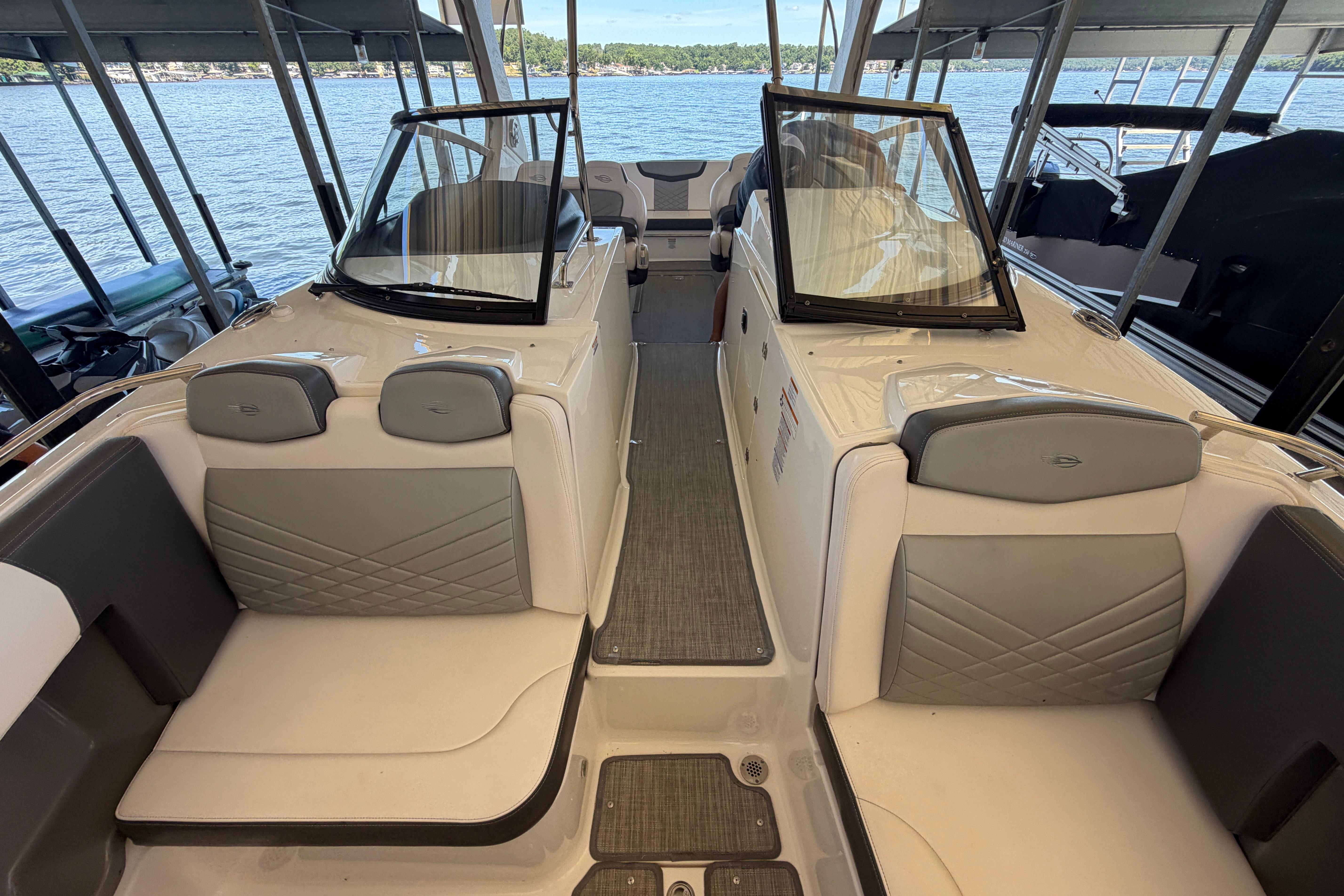 2018 Chaparral 347 SSX boat interior with seating and windshield, docked by the water.