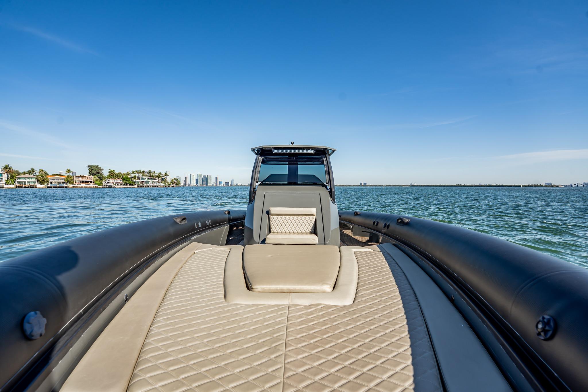 2023 Skipper-BSK 38NC luxury boat on calm waters with city skyline.
