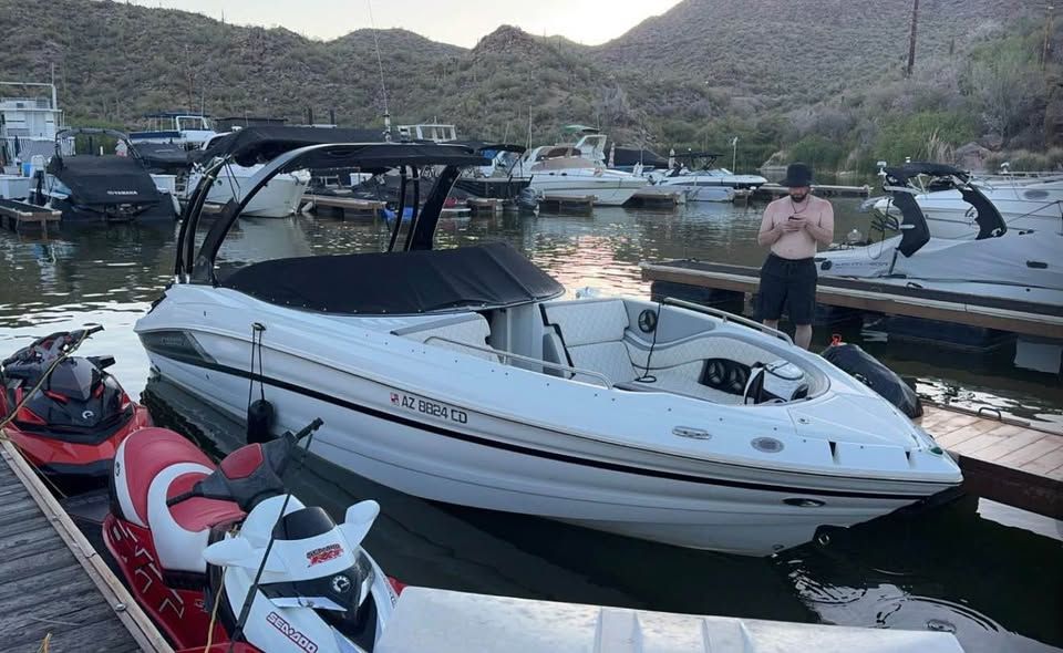 2016 Cruisers Sport Series 29SS boat docked with jet skis.