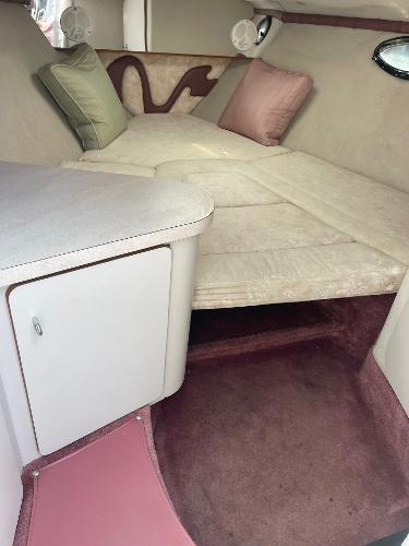 Interior of 1992 Regal Ventura boat with cushioned seating and storage.