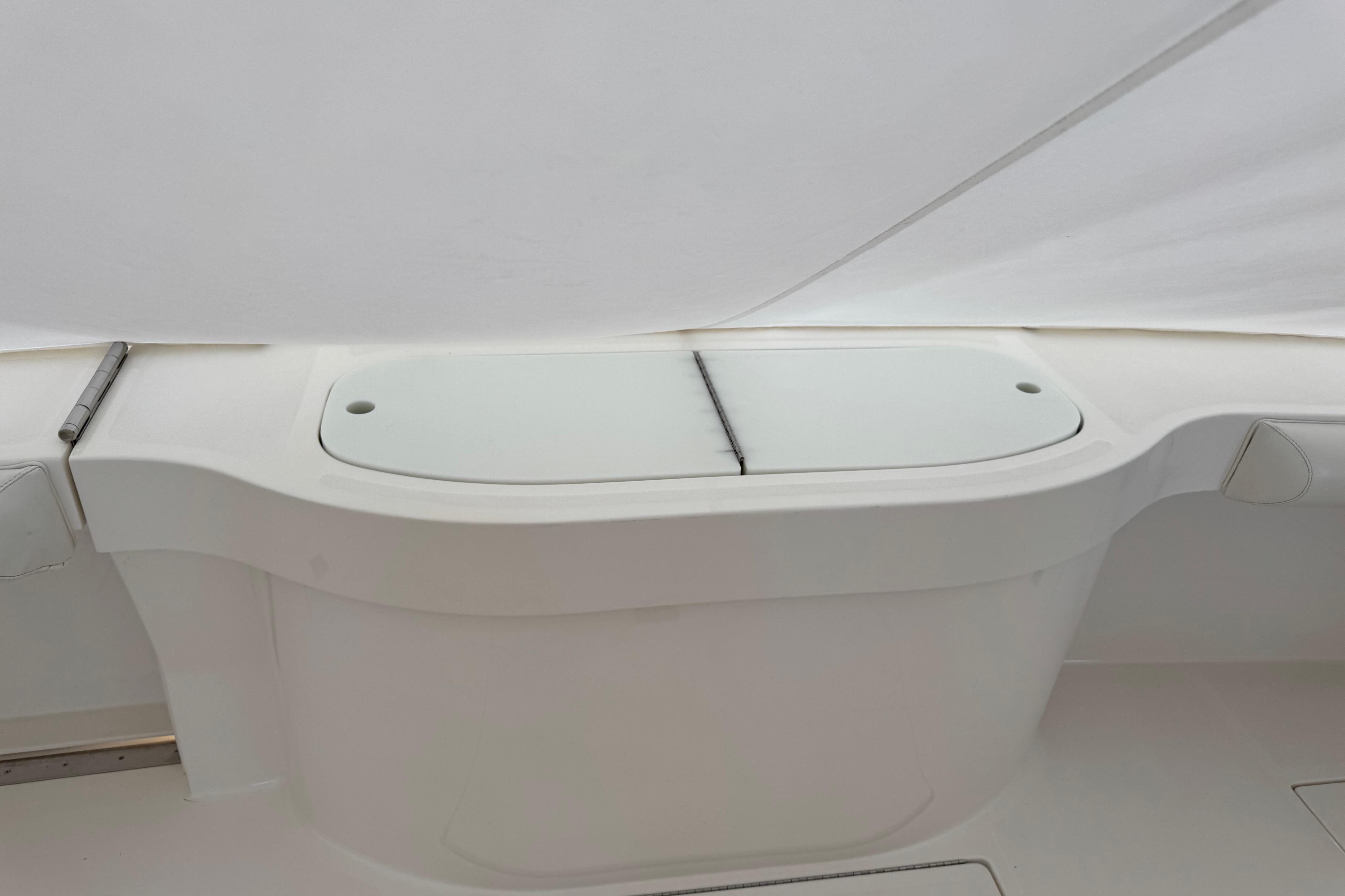 2013 Cabo 44 Hardtop Express boat interior detail with white storage compartment.