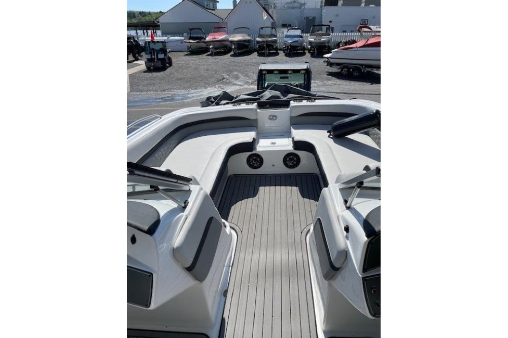 2023 Hurricane SunDeck 217 OB boat interior with seating and speakers.