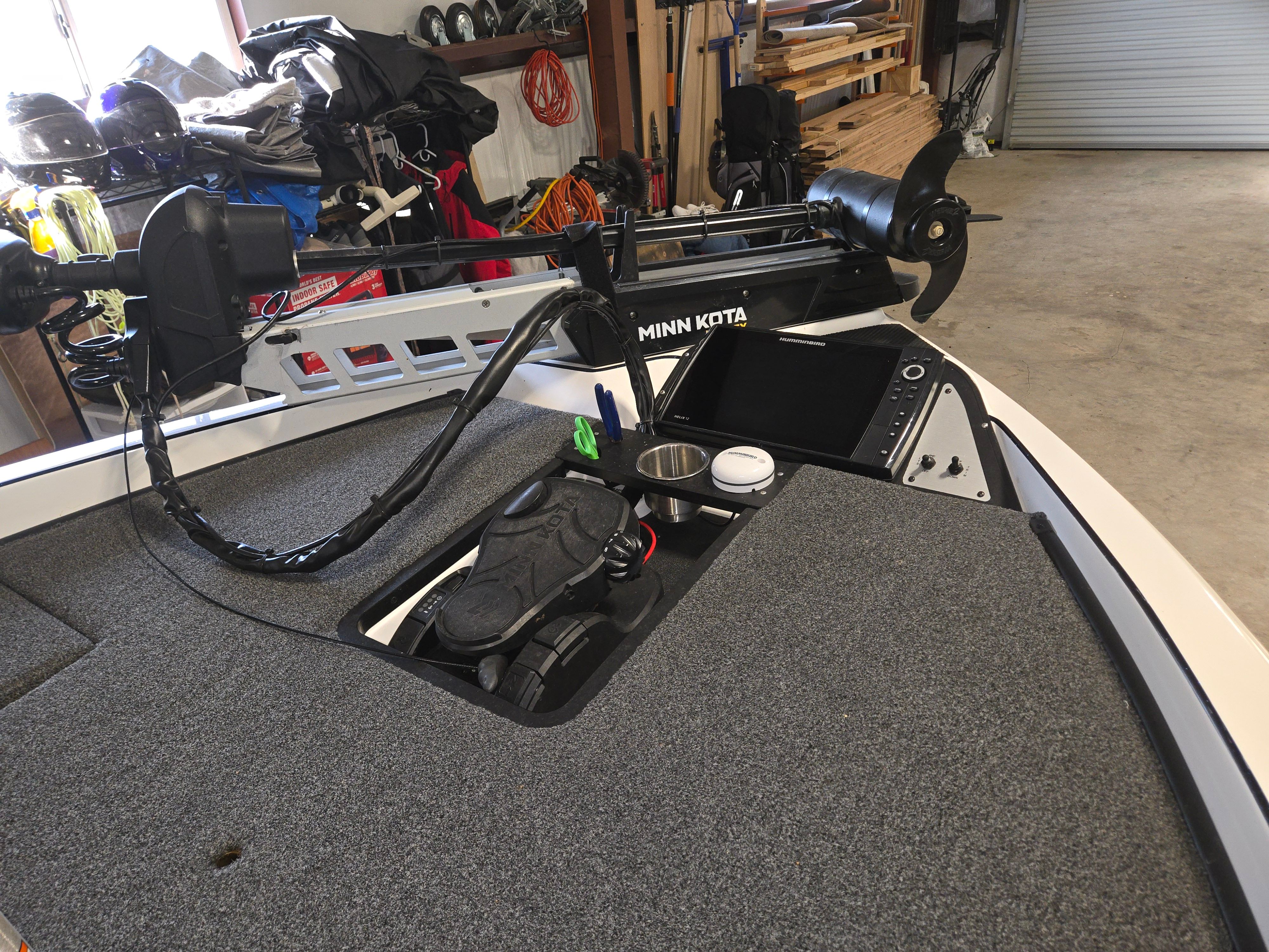 The image shows the deck of a 2022 Caymas CX 19 boat with fishing gear.