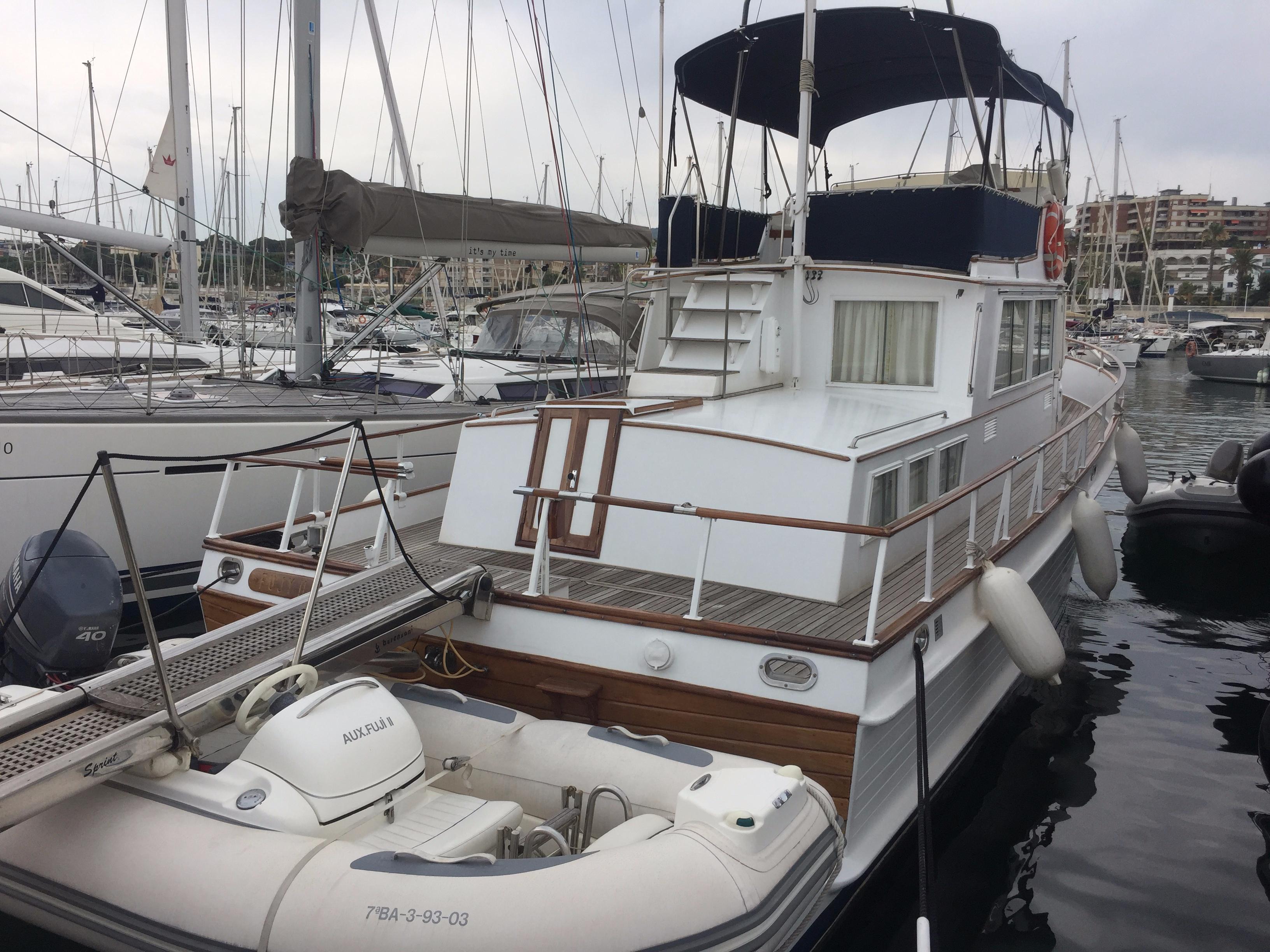 1980 Grand Banks 42 Classic yacht docked with inflatable boat.
