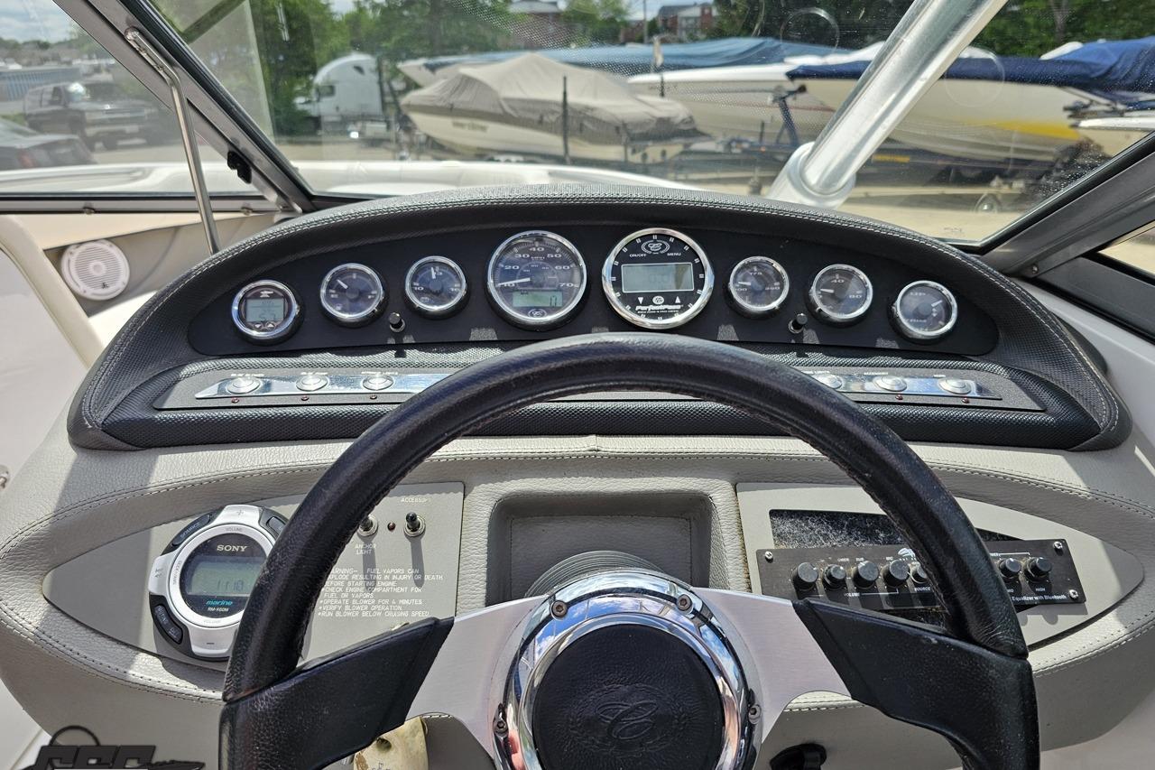 Dashboard of a 2010 Cobalt 232 WSS boat with gauges and steering wheel.