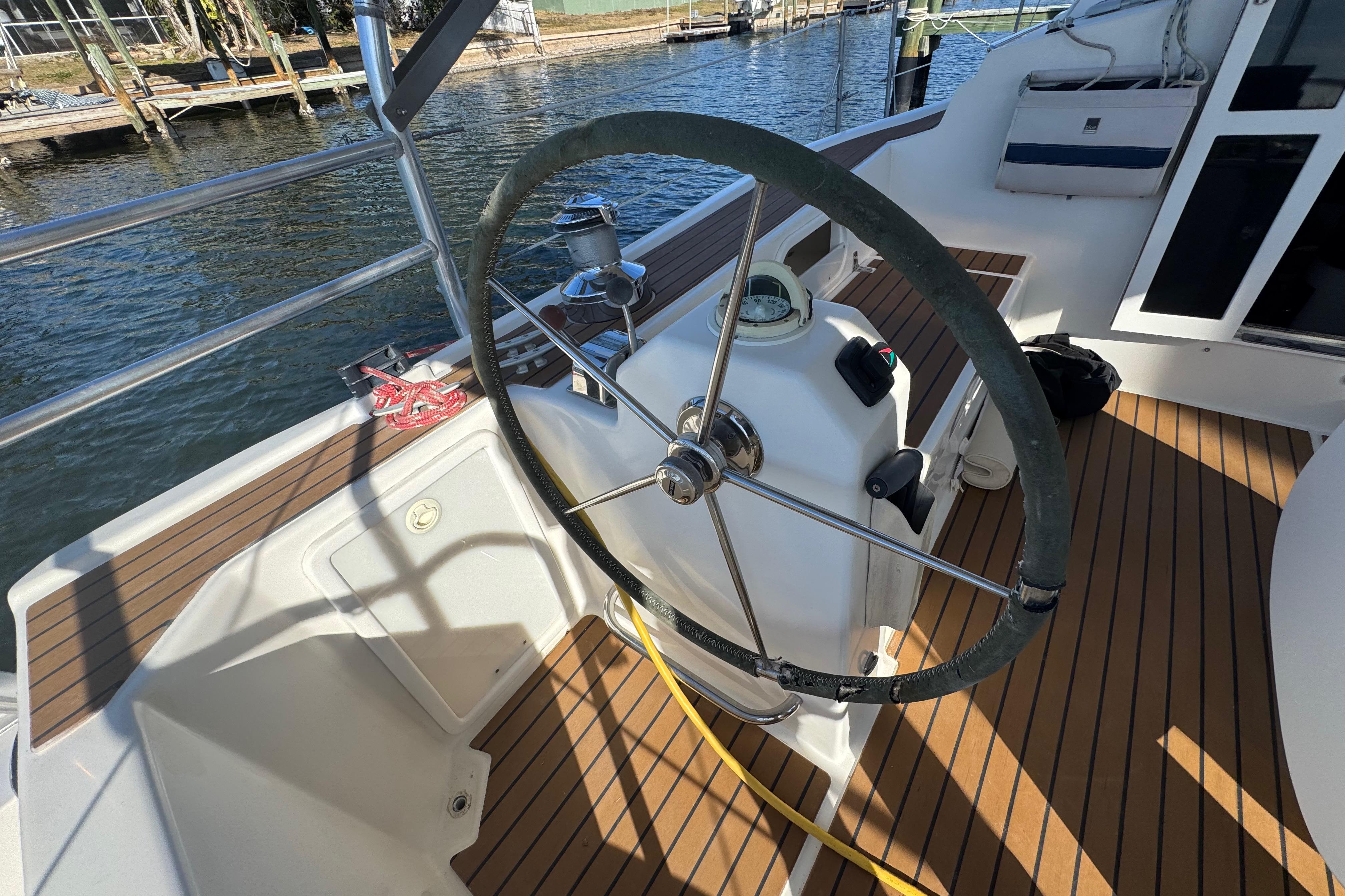 Steering wheel of a 2006 Shannon Shoalsailer yacht on a sunny day.