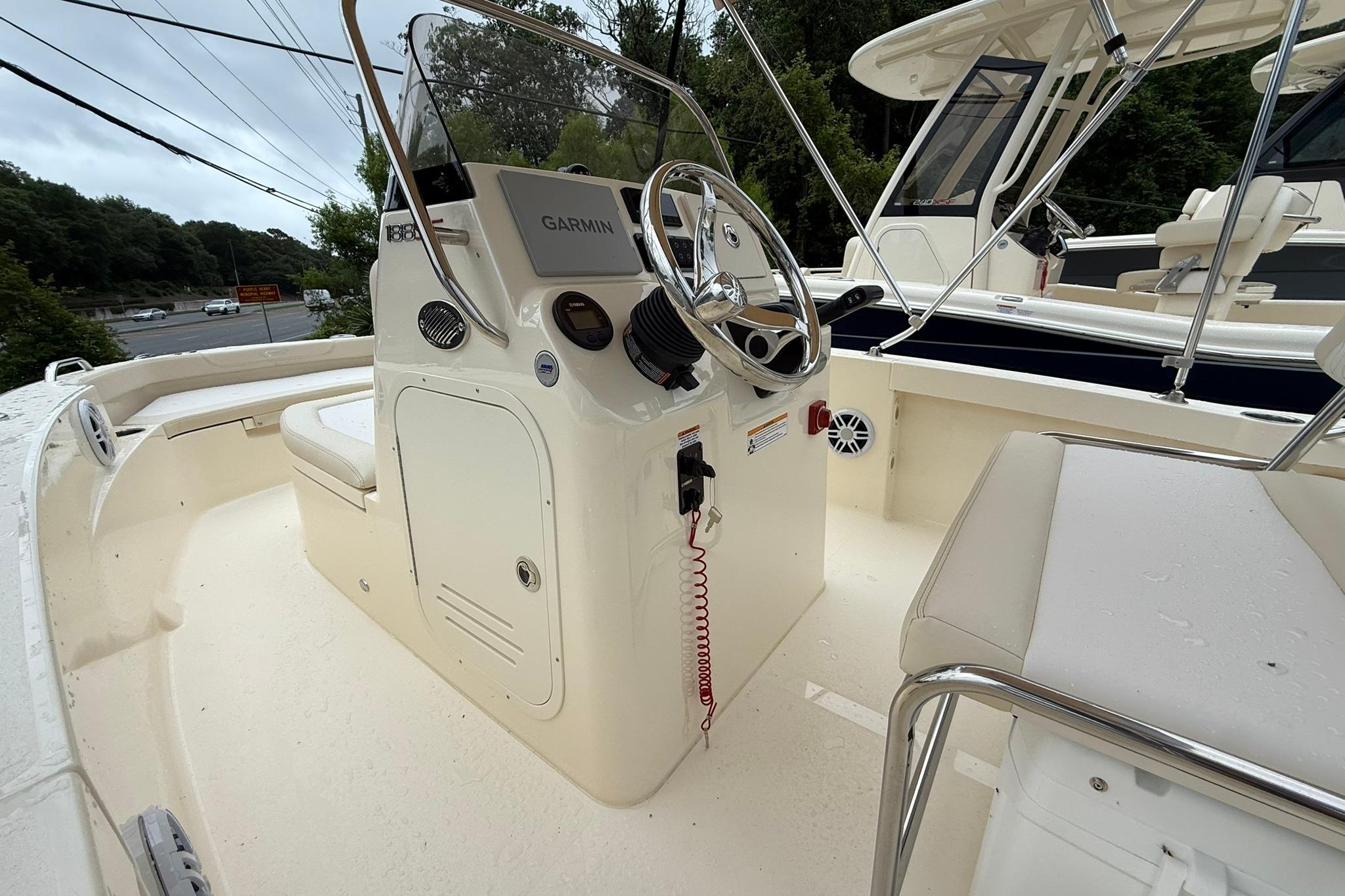 2027 Scout 188 Sportfish boat interior with steering console and seating.