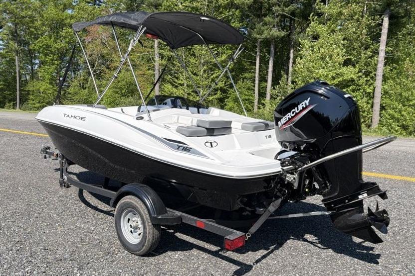 2026 Tahoe T16 boat with Mercury engine on trailer, parked outdoors.