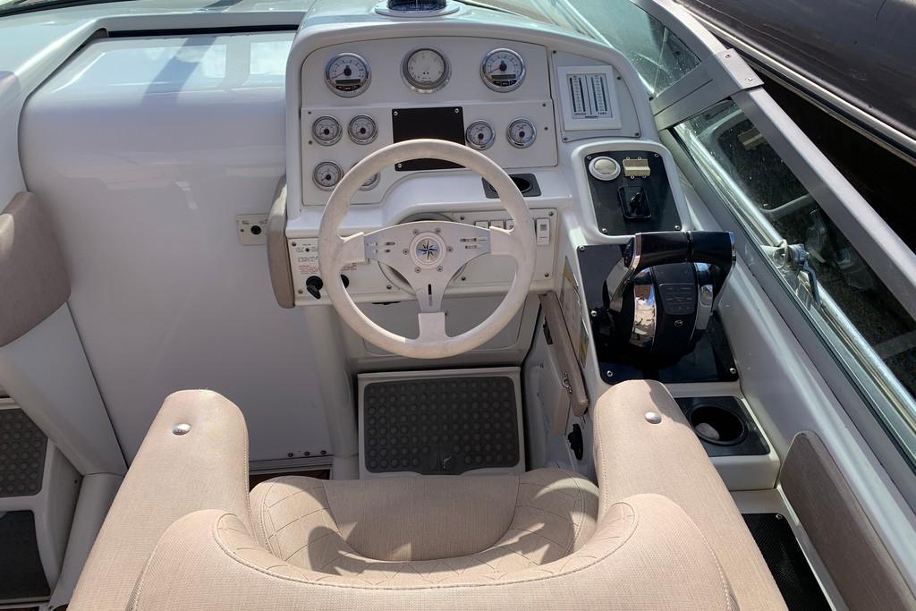 1999 Formula 382 FASTech boat cockpit with steering wheel and control panel.