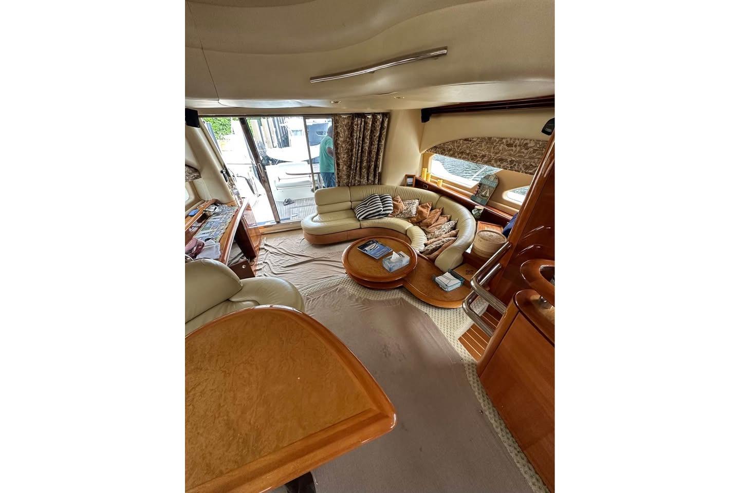 Luxurious interior of a 2004 Azimut 55E yacht with elegant seating and decor.