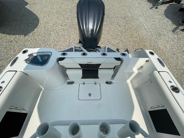 2025 Tidewater 232 CC Adventure boat interior with motor, rod holders, and seating.