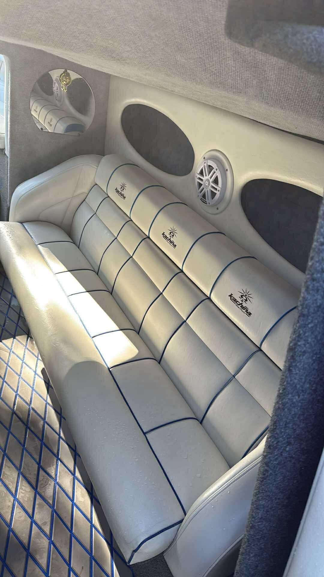 2005 Kachina Bolero interior with white leather seating and blue accents.