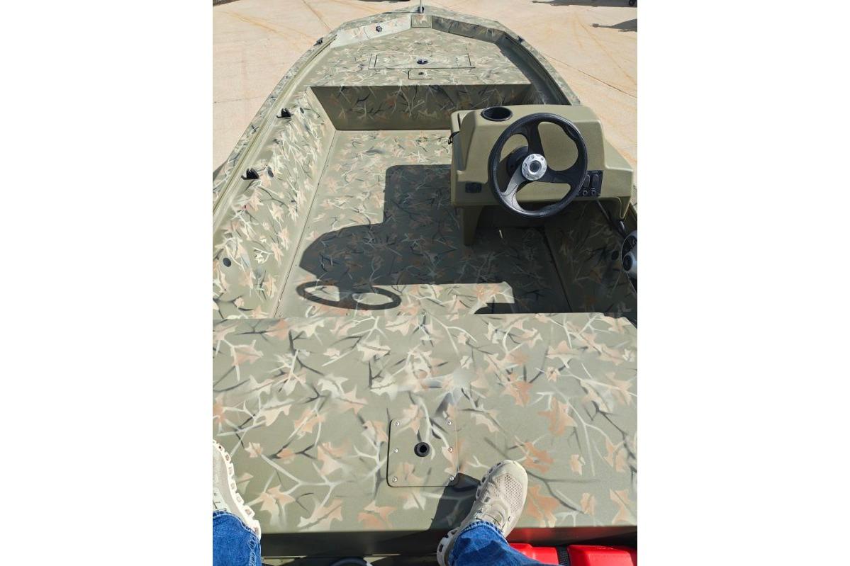 2025 Tracker Grizzly 1648 SC boat interior with camouflage design and steering console.