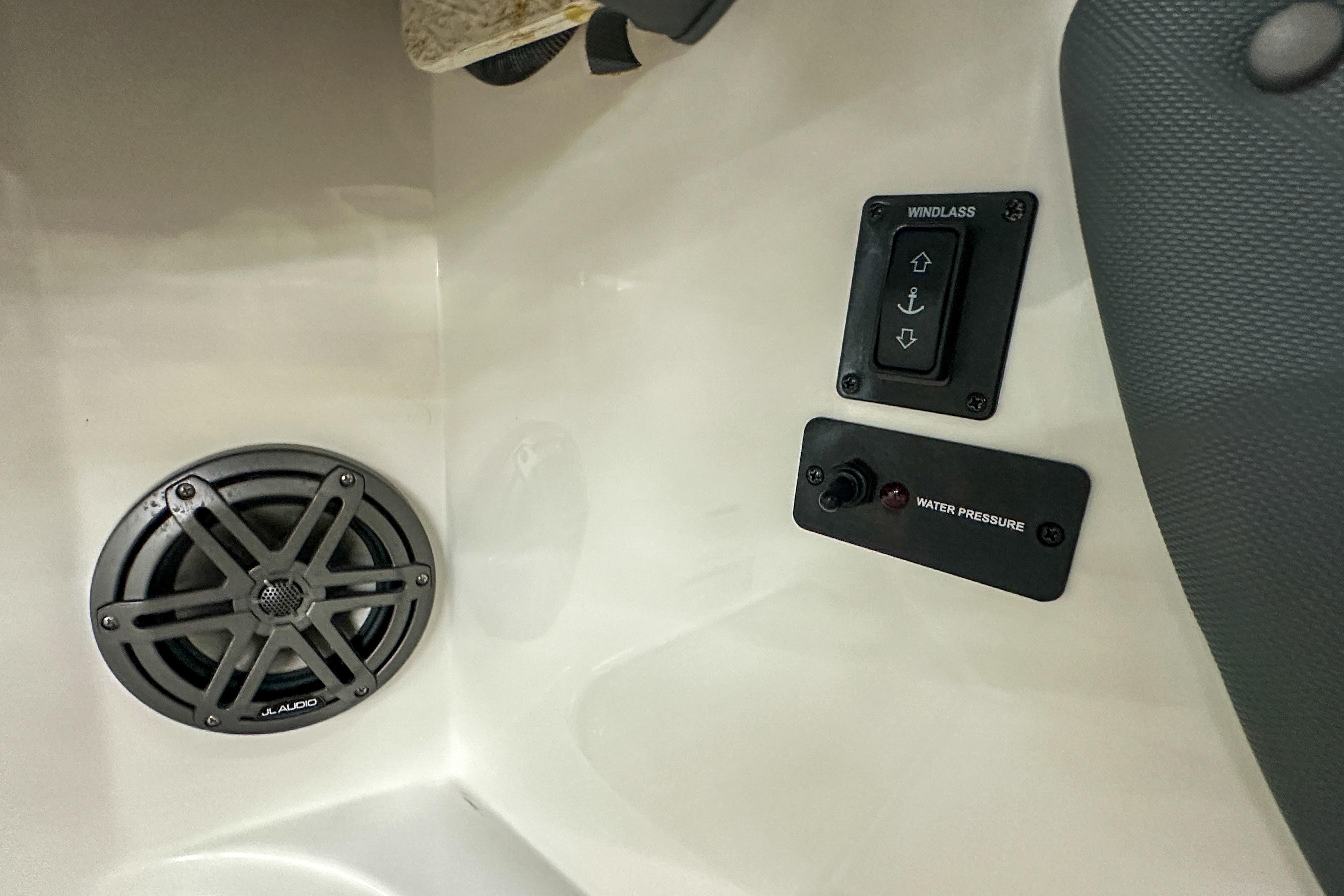 2022 Cobalt 25SC boat interior with speaker, windlass, and water pressure controls.