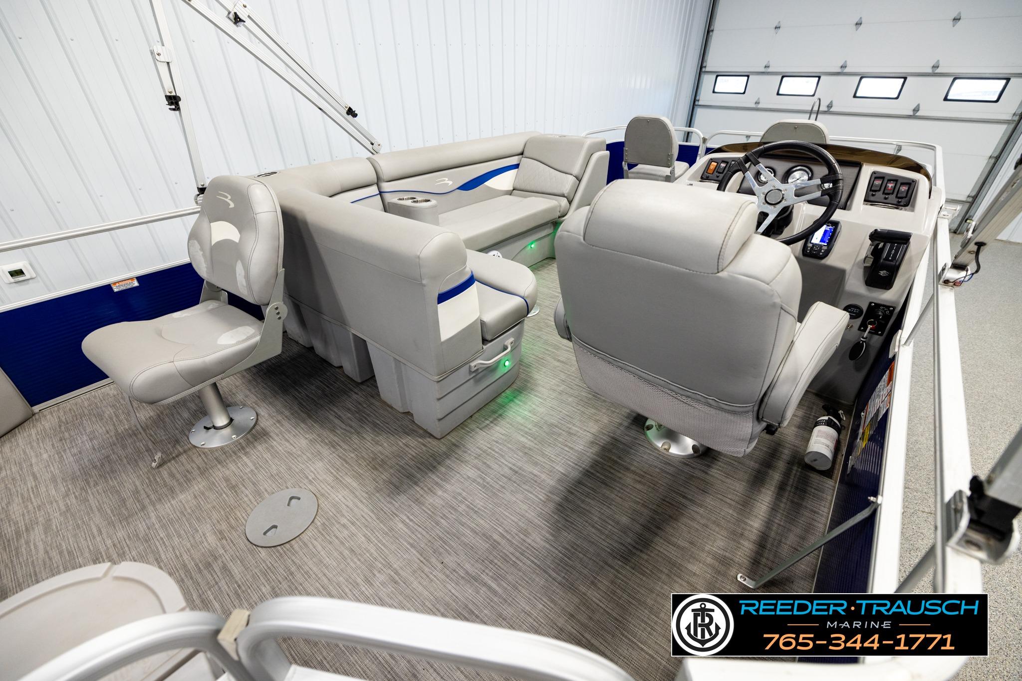 Interior of a 2021 Bennington 20 SV pontoon boat with gray seating and modern controls.