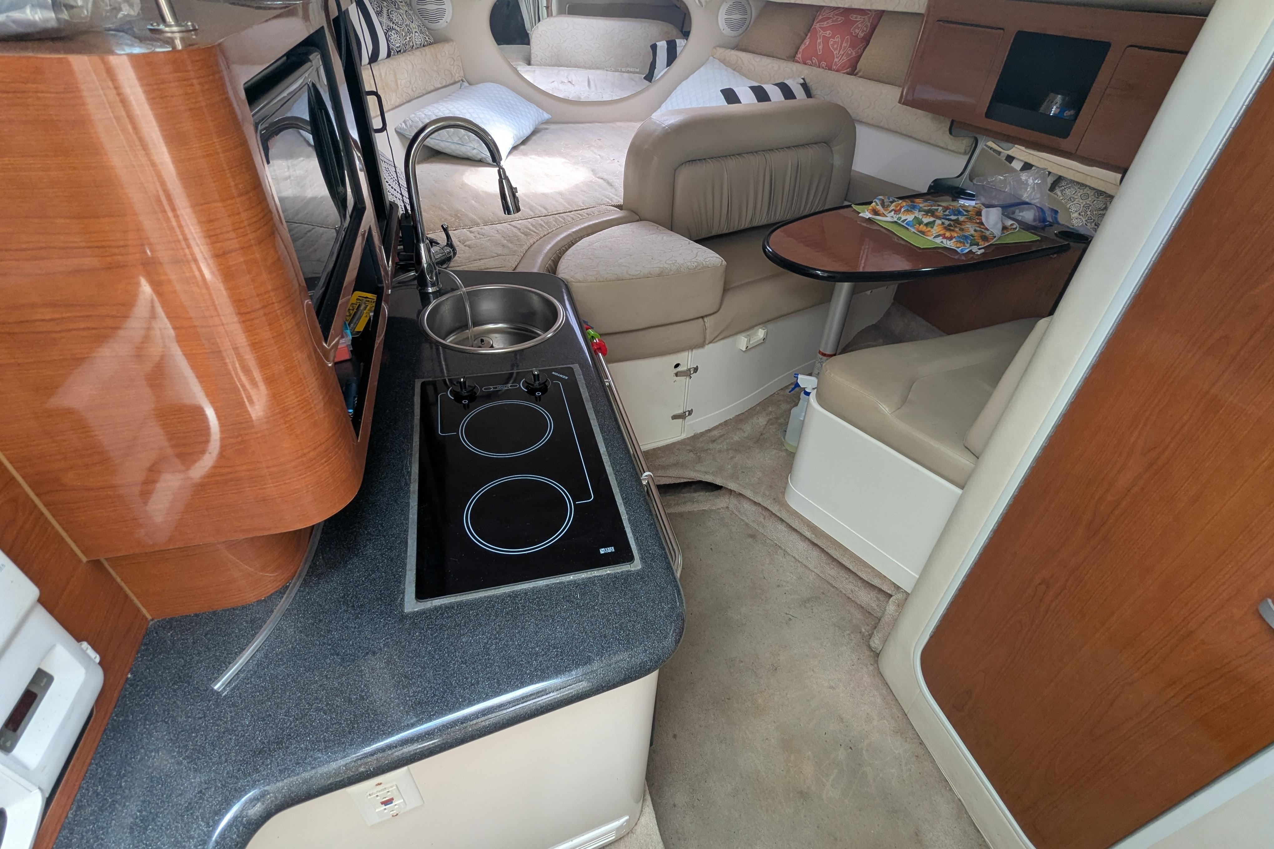 Interior of a 2003 Monterey 282 Cruiser with kitchenette and seating area.