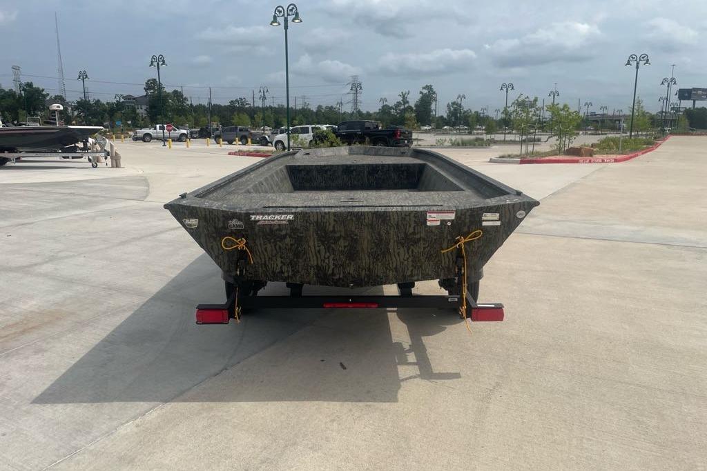 2025 Tracker Grizzly 1860 Utility boat on trailer in parking lot.