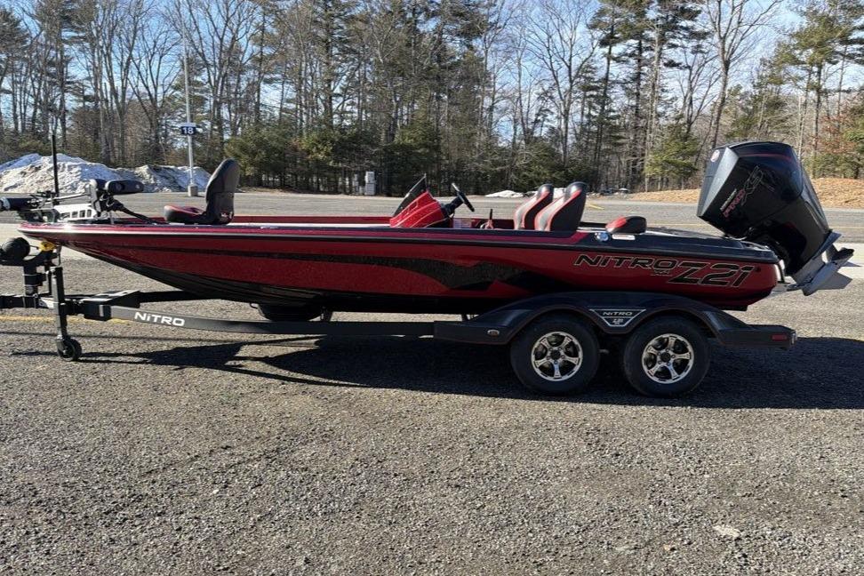 2026 Nitro Z21 XL Pro boat on trailer in parking lot, surrounded by trees.