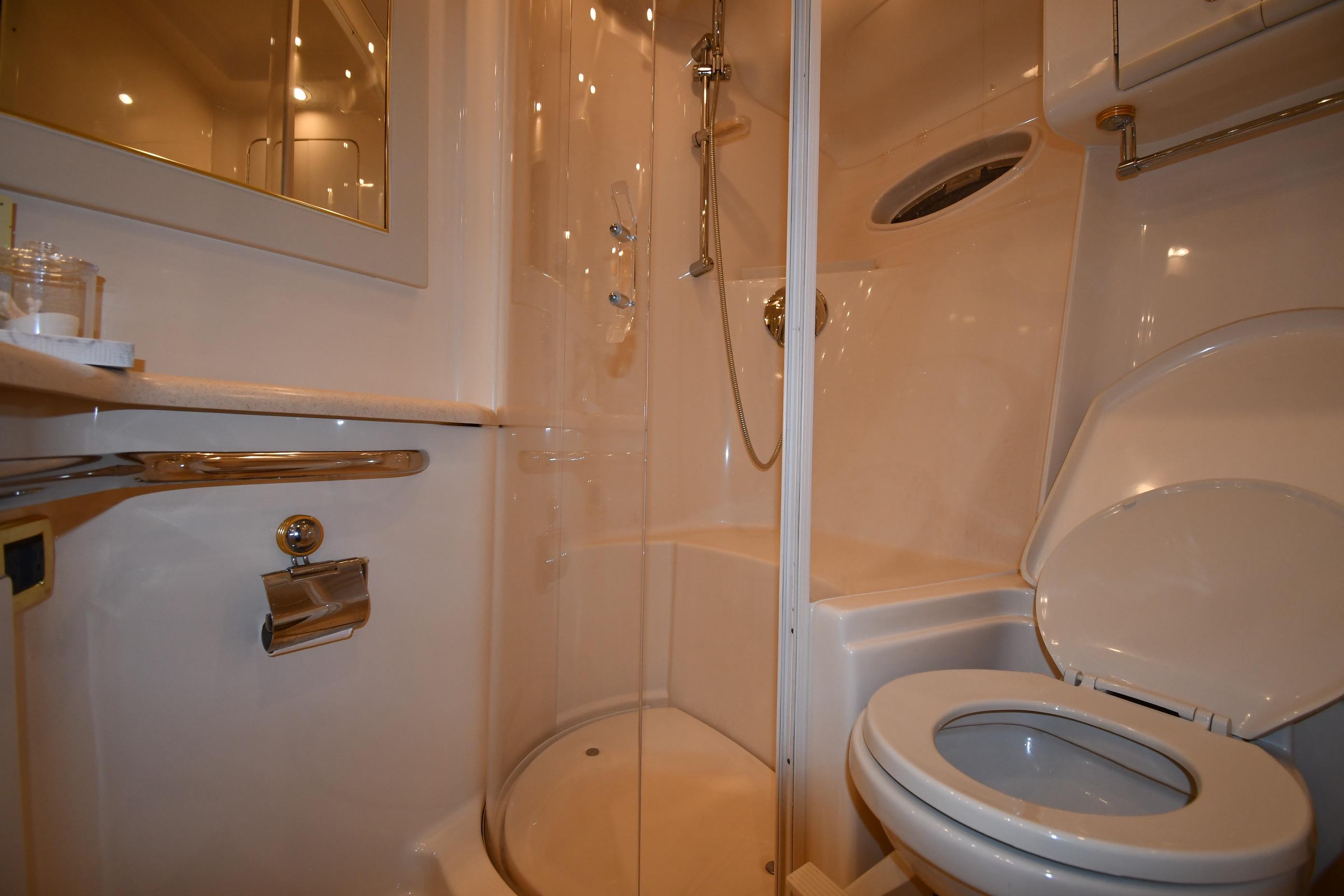 Bathroom interior of 2001 Sea Ray 540 Sundancer yacht, featuring shower and toilet.