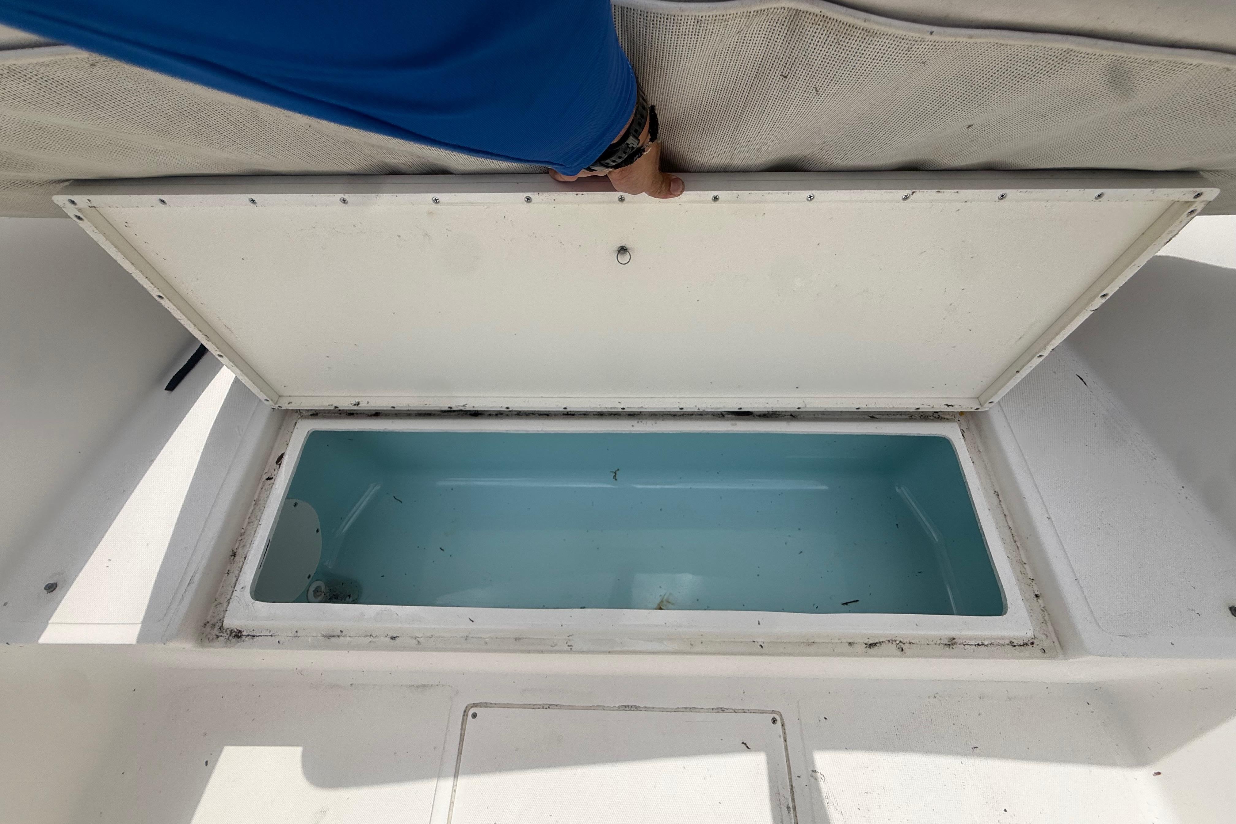 Open storage compartment on a 2012 Clearwater 2000 Center Console boat.