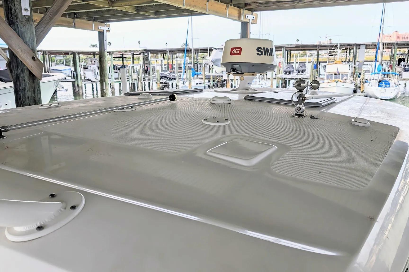 2017 Boston Whaler 320 Vantage boat docked, featuring radar equipment and marina background.