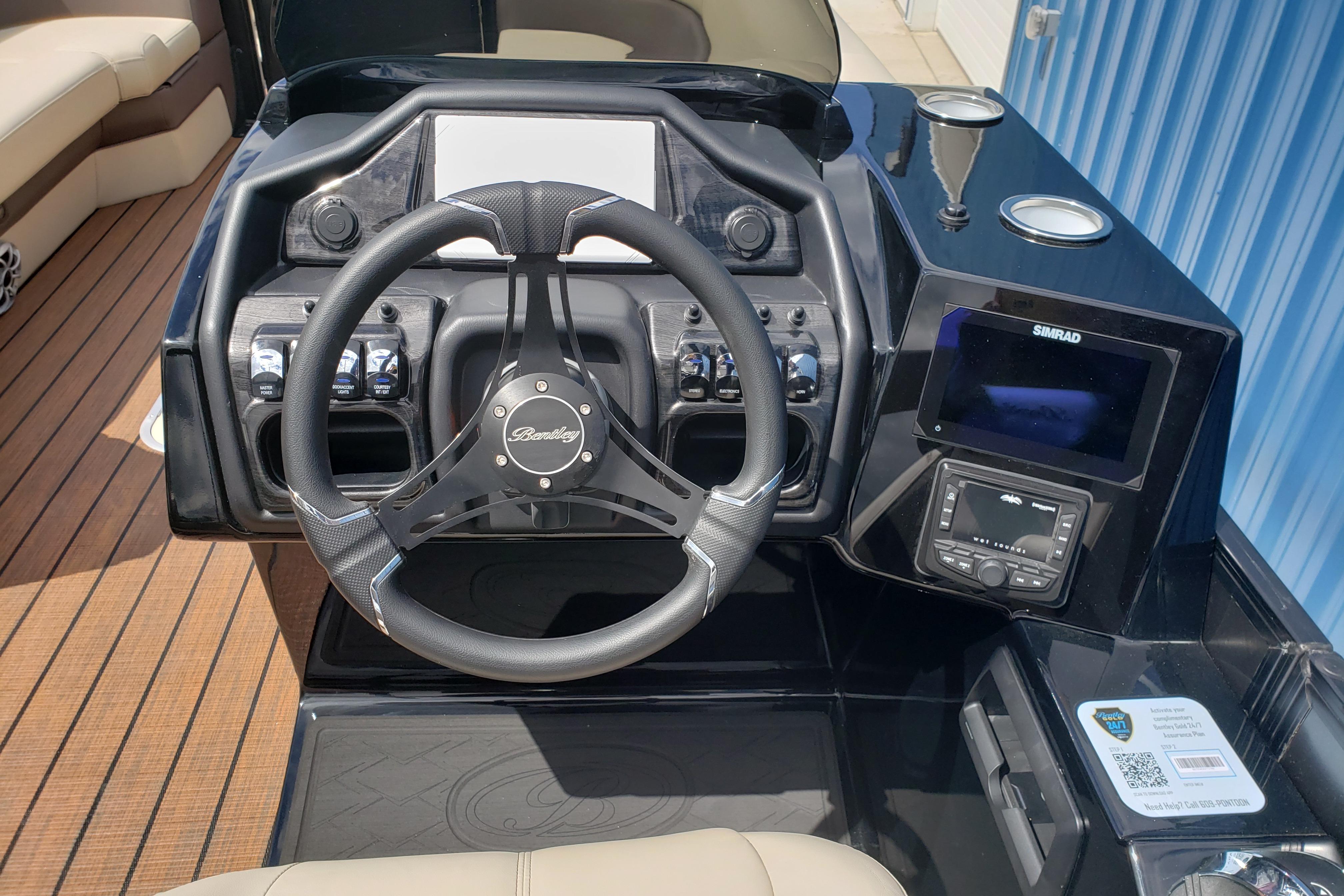 Steering console of 2026 Bentley Pontoons Elite 253 QSB with modern controls and display.